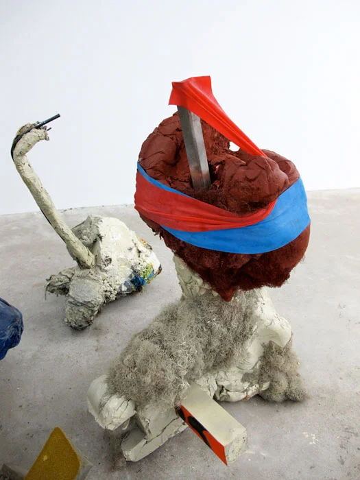 Jo Nigoghossian, Stomps, aka Spito , 2011, cast concrete, wood, spray paint, fake hair, steel, elastic, burlap, 47 x 31 x 25 in