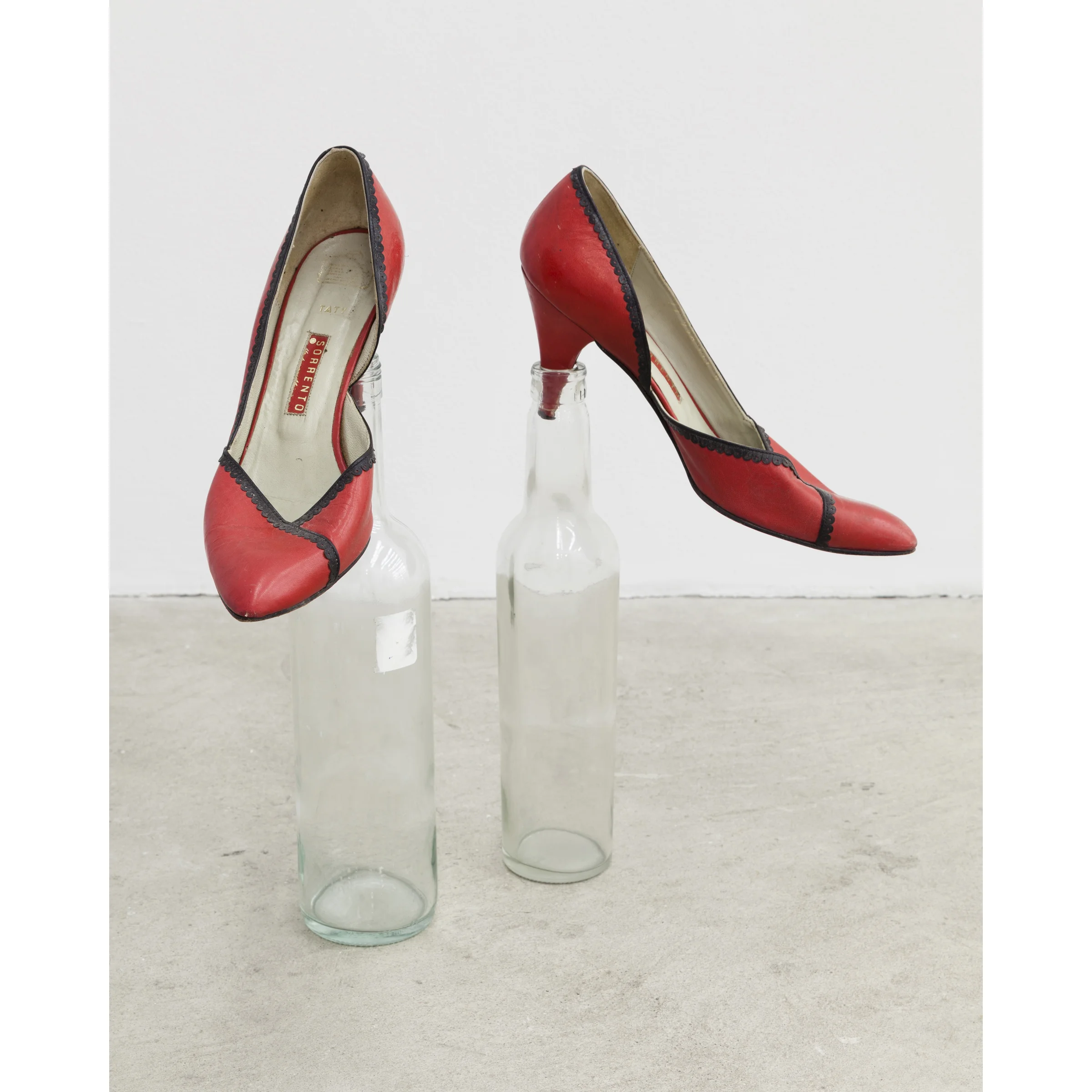 Martin Soto Climent, Poking Shoes , 2007, women's shoes, two glass bottles, dimensions variable