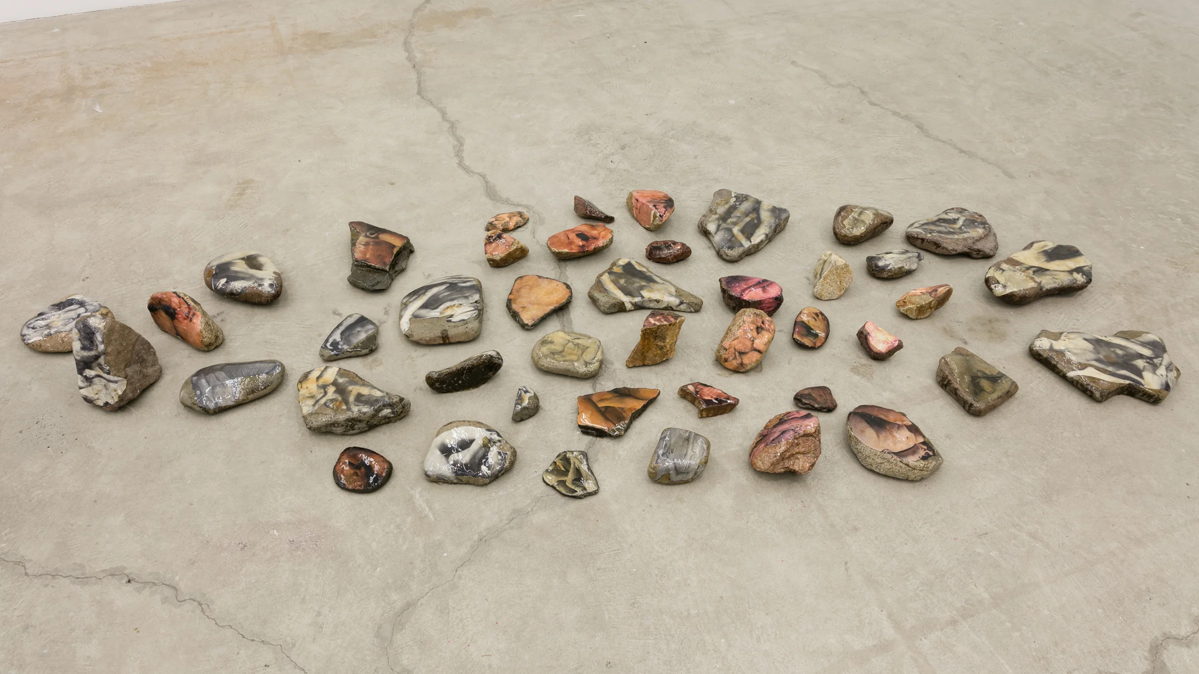 Aura Rosenberg, Dialectical Porn Rocks , 1989-2016, rocks, newspaper, xerox, resin, dimensions variable, Courtesy the Artist and Martos Gallery, New York