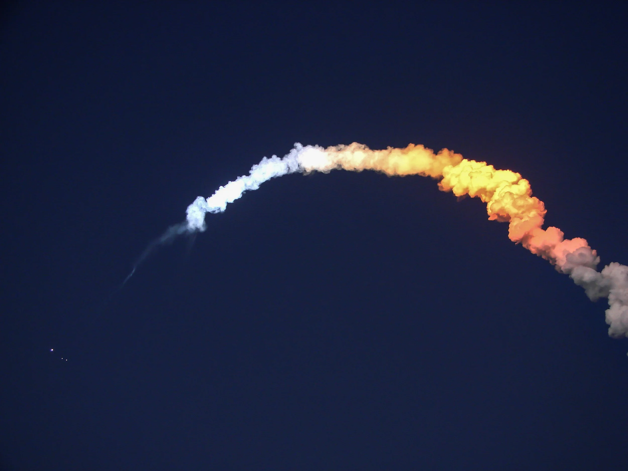 Solid Rocket Booster (SRB) separation can be seen during the the sunset lift off of Space Shuttle Discovery’s STS-119 mission to the International Space Station. March 15th, 2009.