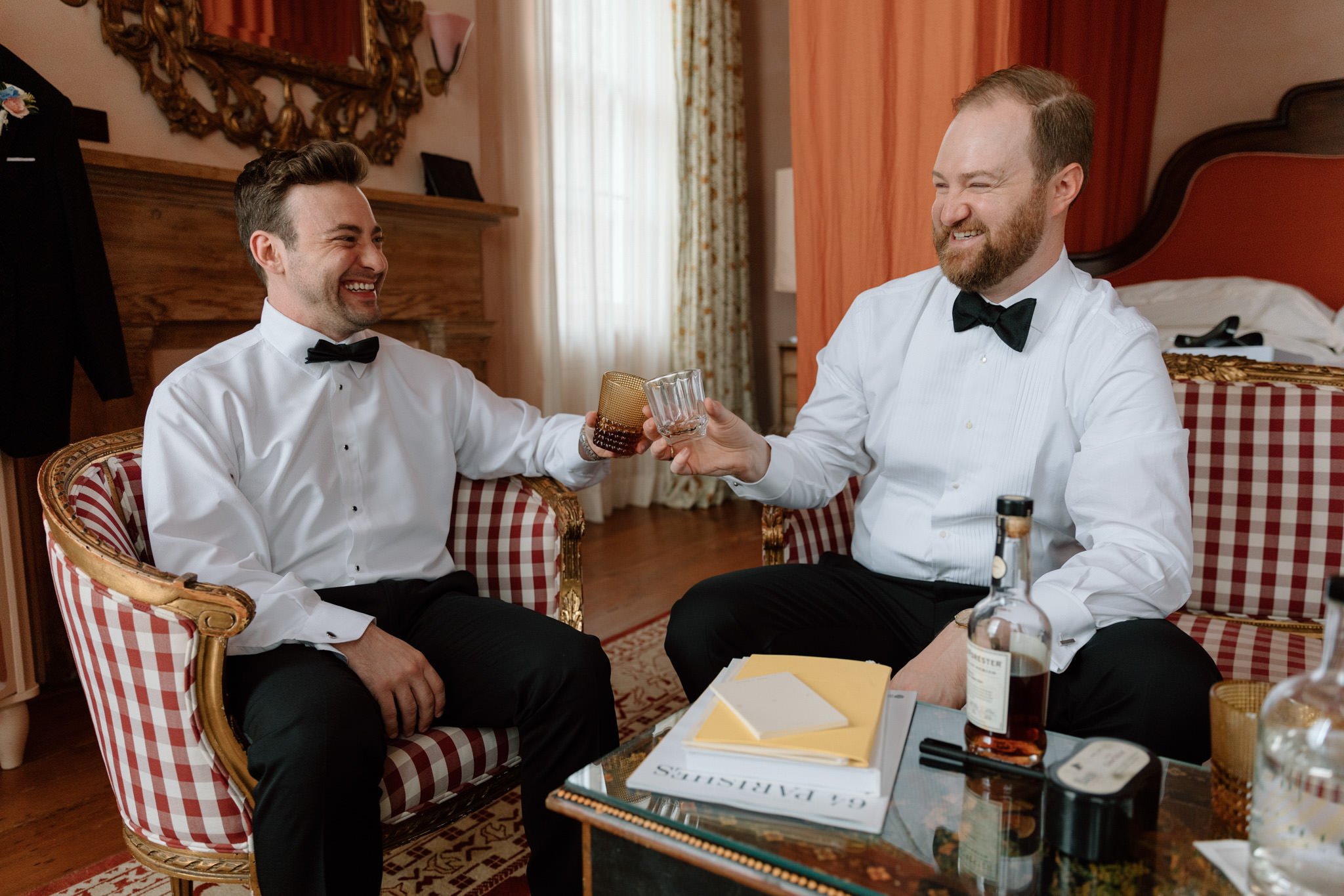 Groom and Best Man toasting whiskey at Hotel Peter and Paul