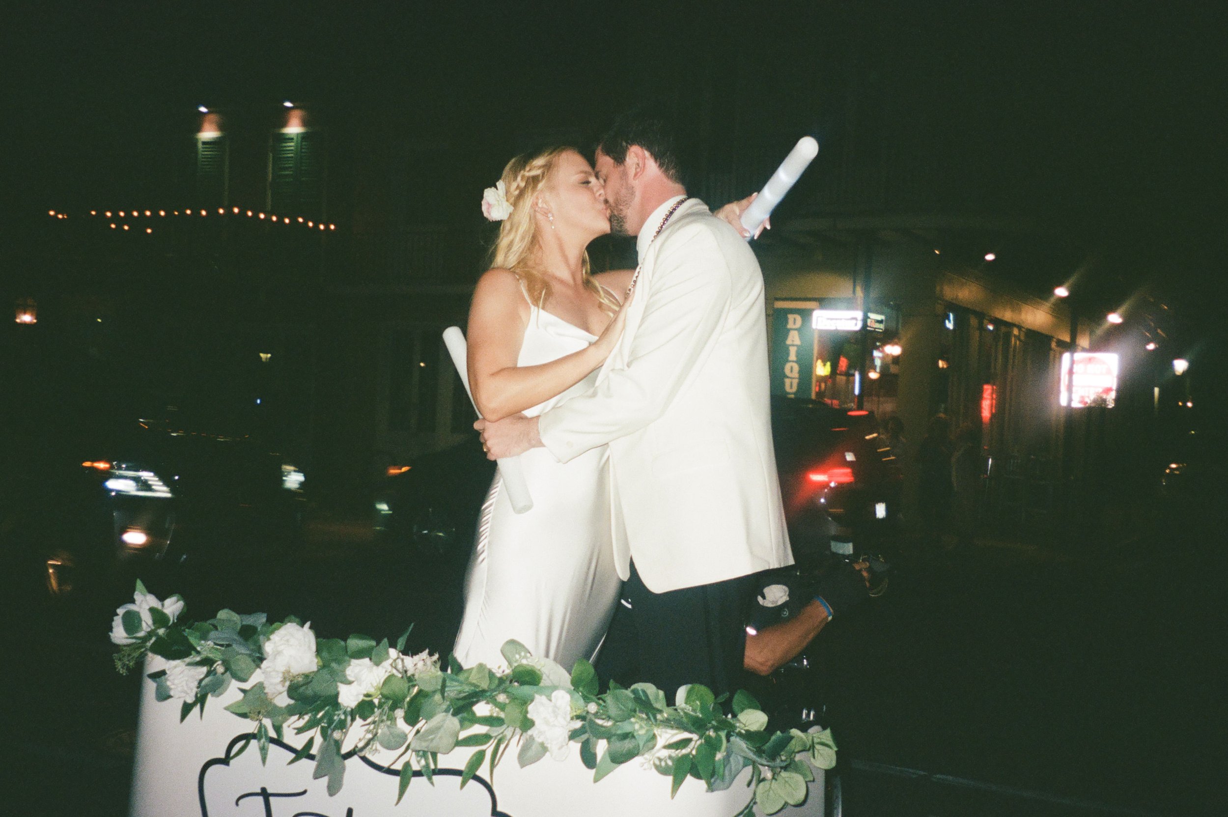 Bride and Groom kissing on a pedicab in the French Quarter