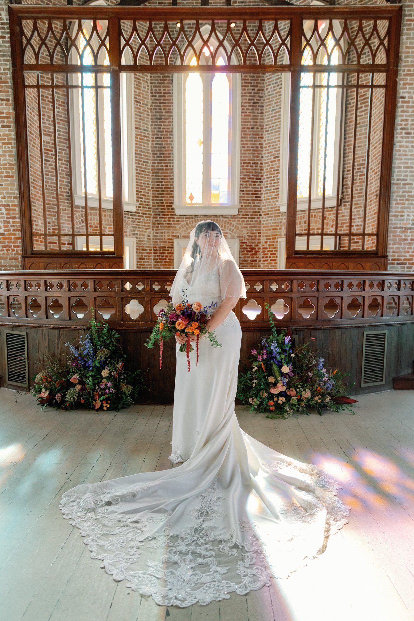 Bride surrounded by florals in Felicity Church