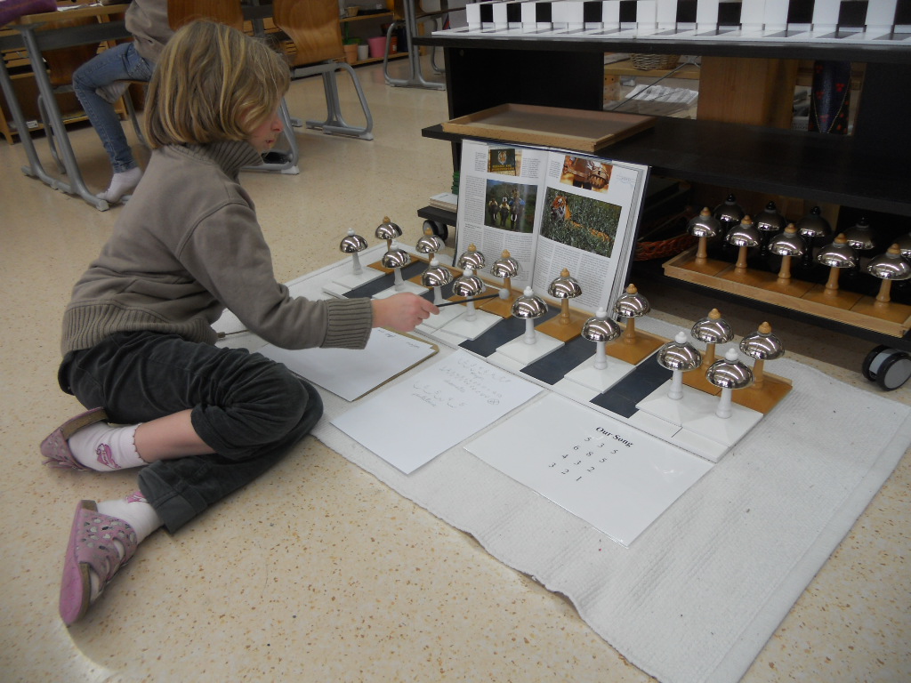 An elementary child composing a song about tigers with the Bells.