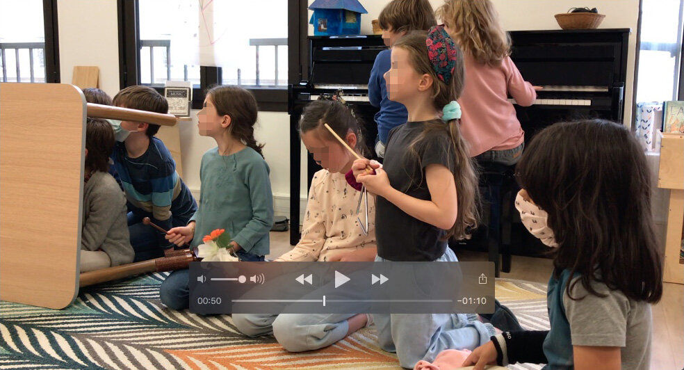 A still from a video of the show. the orchestra is awaiting their cues. The pianists, however, are watching and improvising.