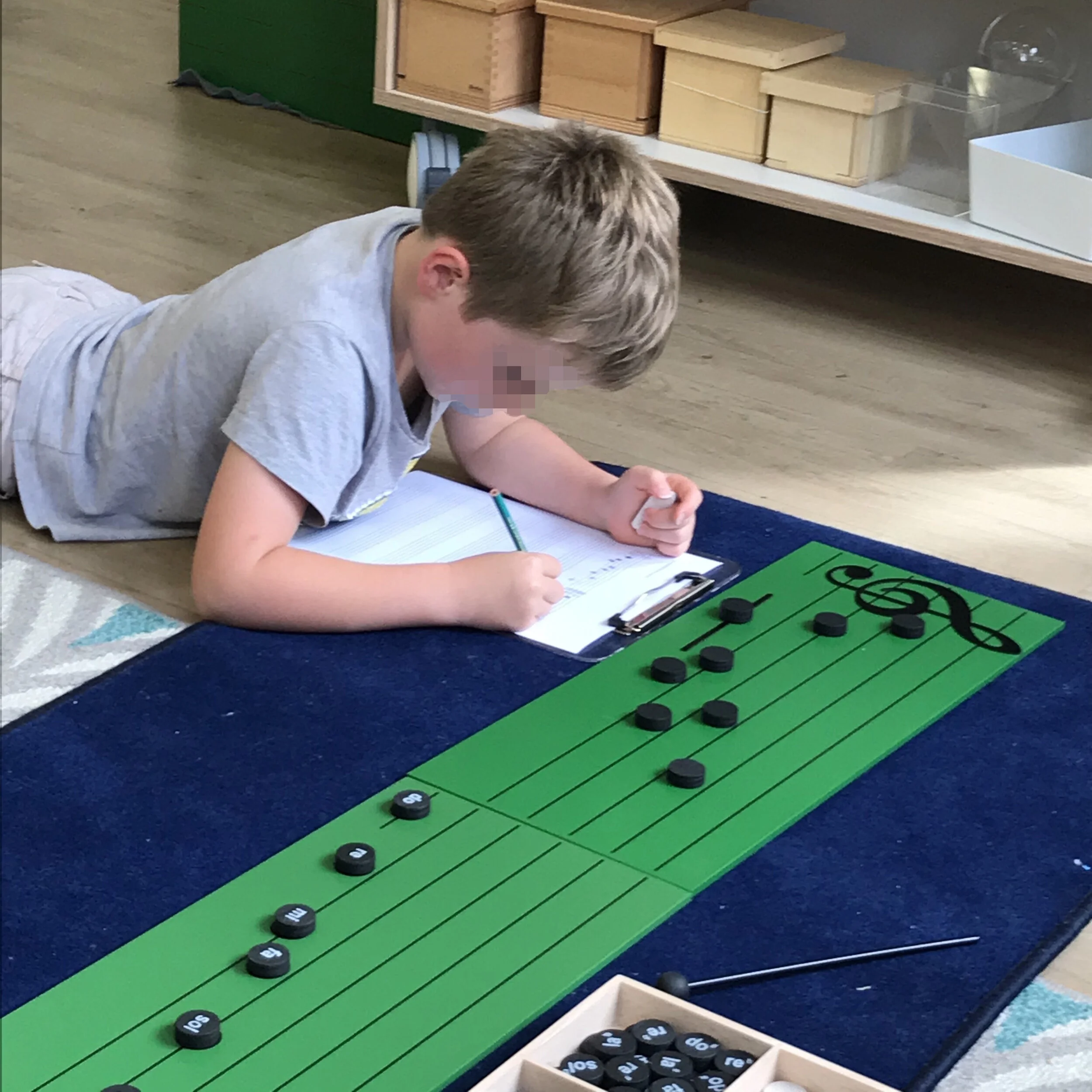 If you’ve given the literacy lessons, encourage the child to sing the notes as he places them on the staff board.