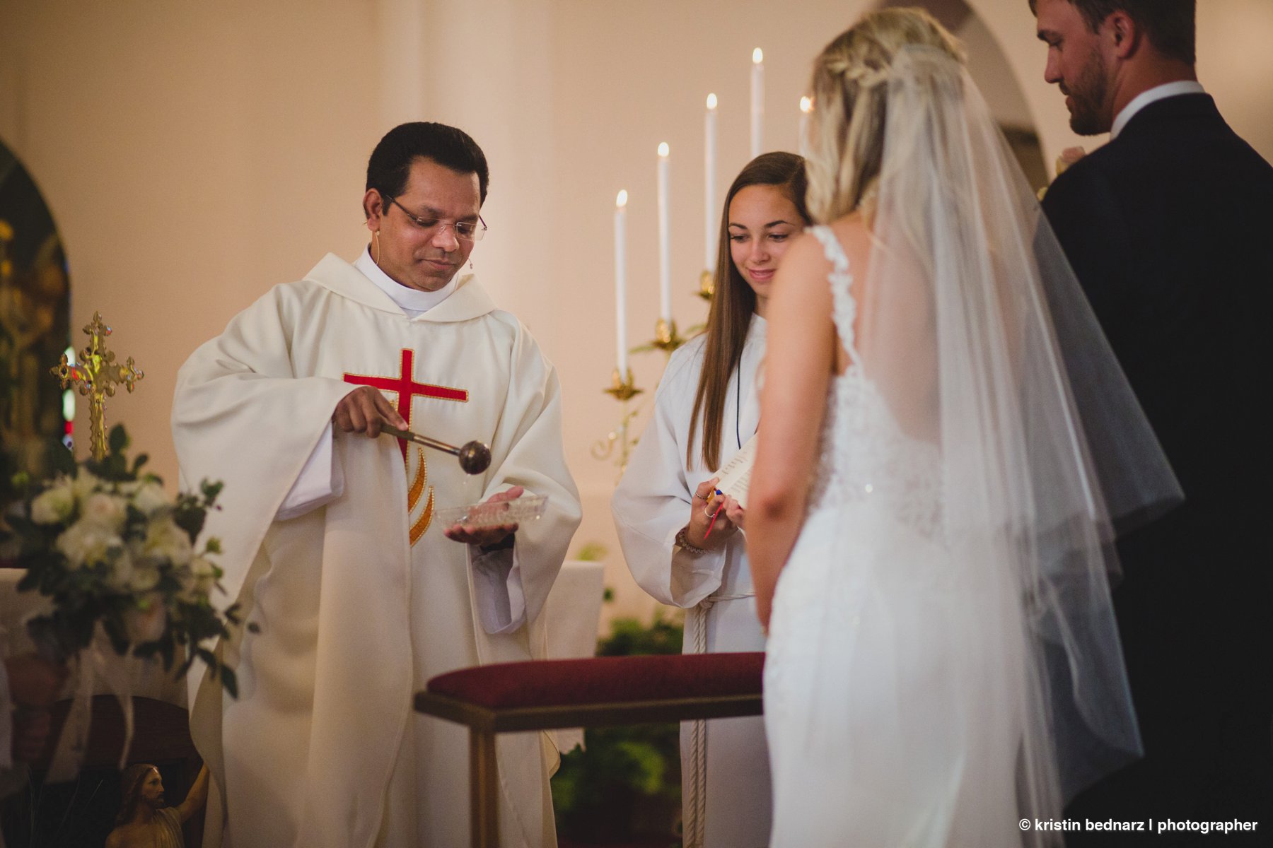 Blessing the rings with Holy Water.
