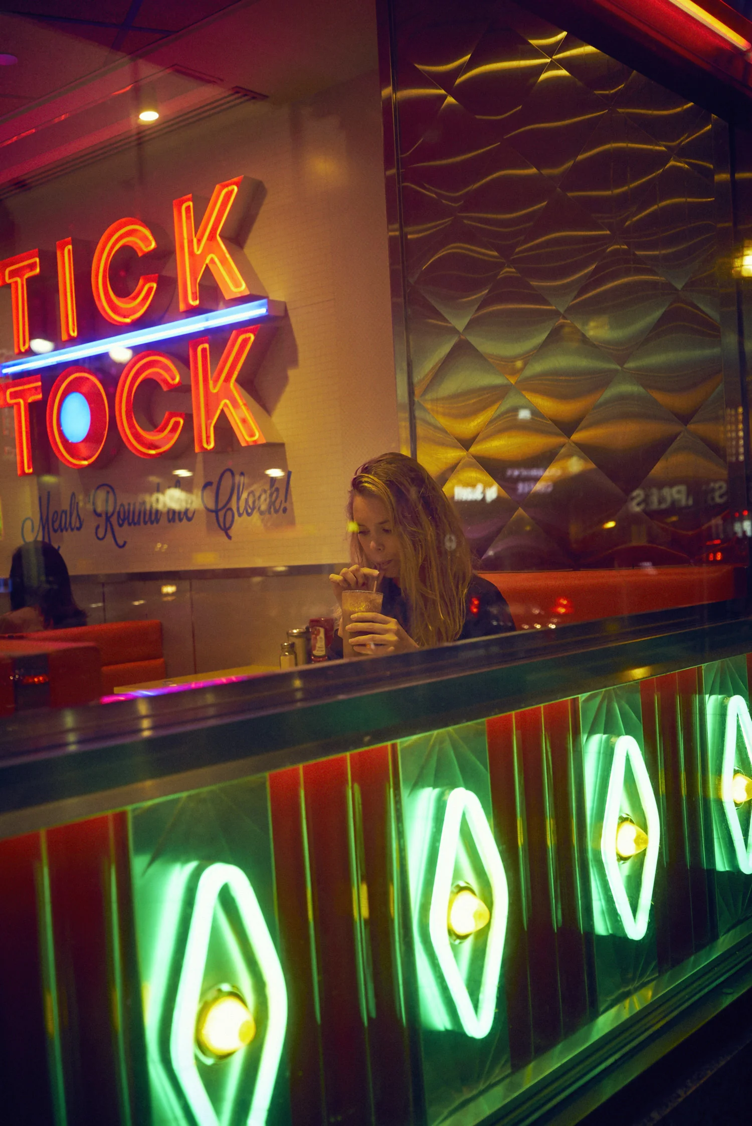 Girl drinking milkshake at Tick Tock Diner.jpg