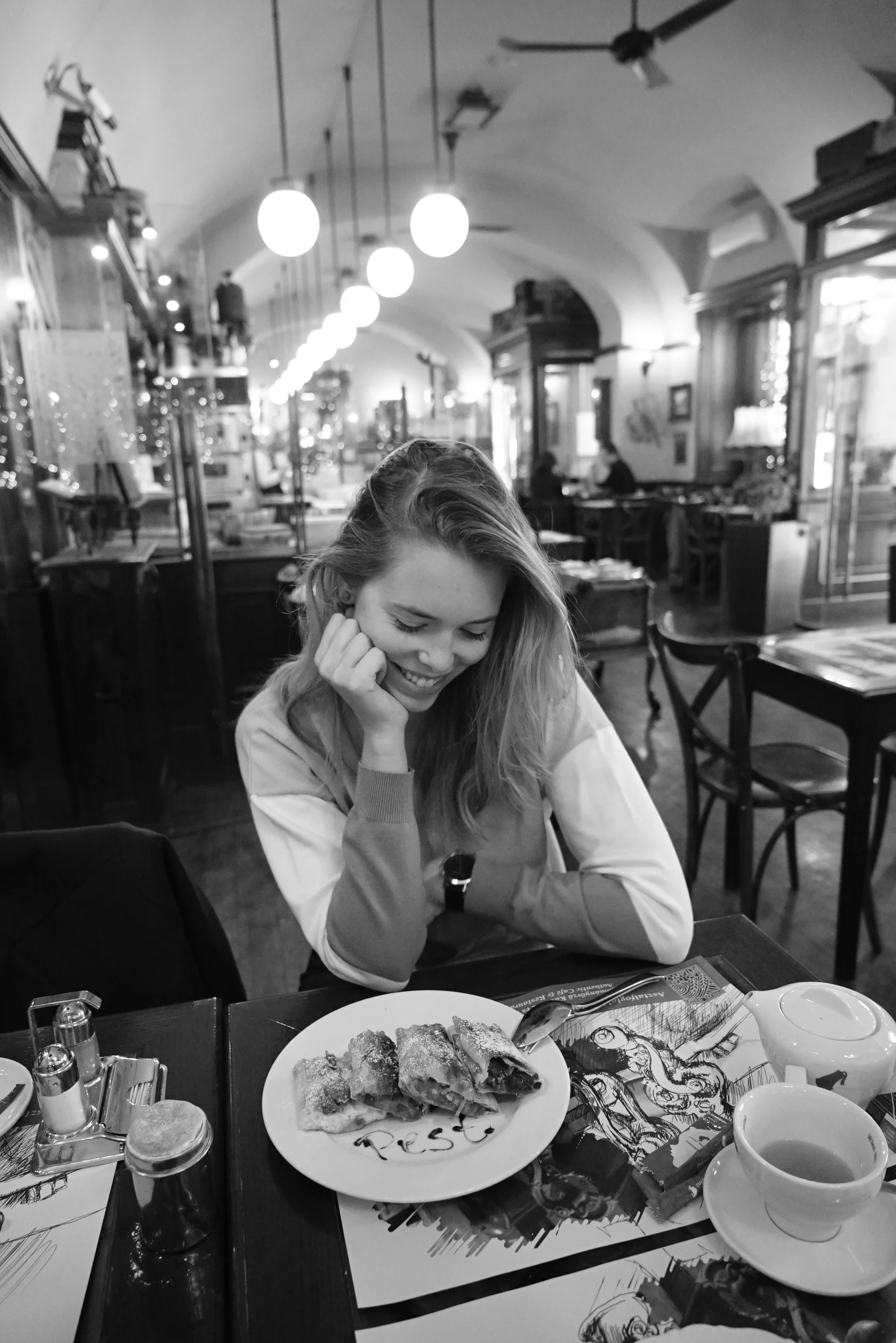 Girl eating strudel in Budapest cafe