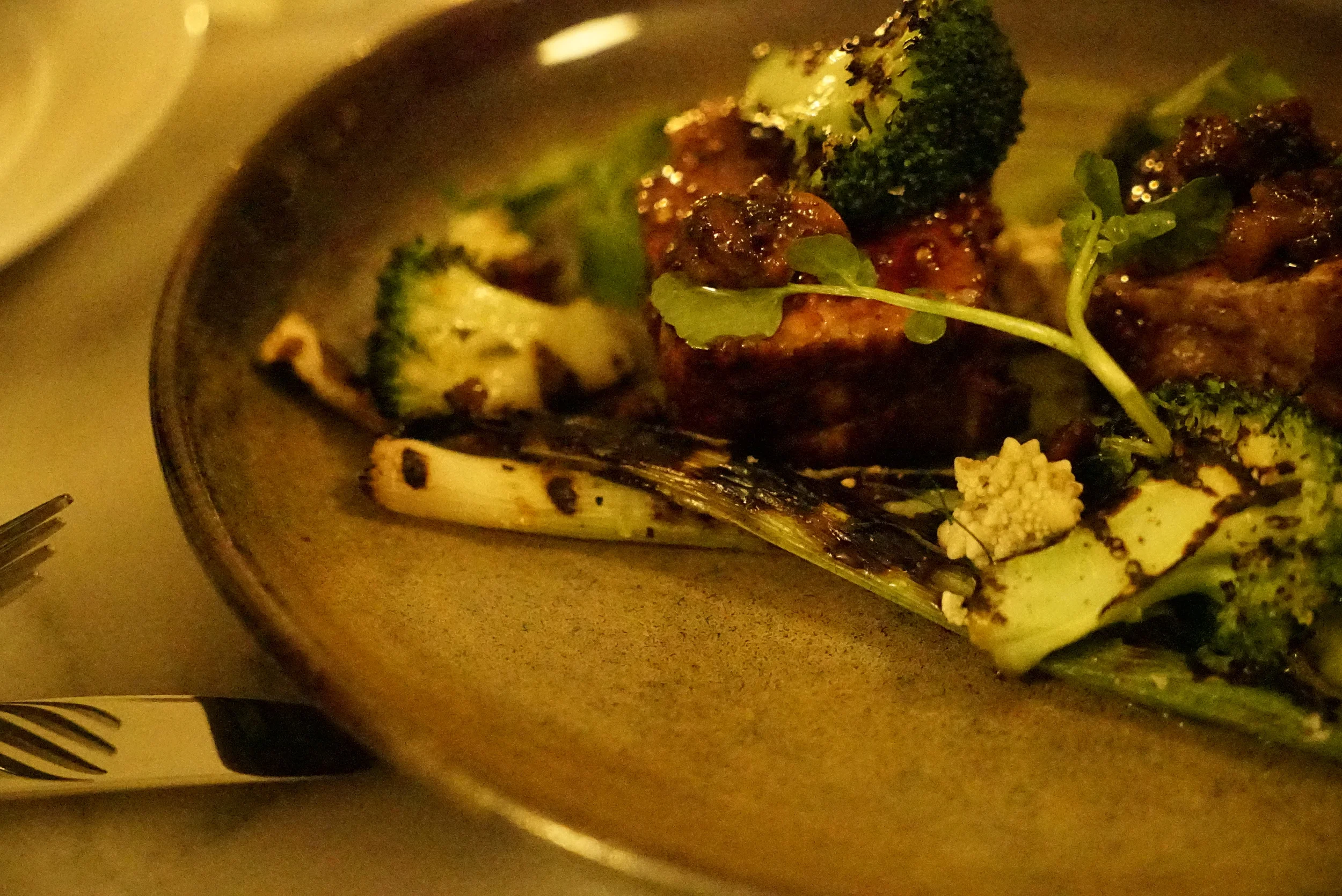 Pork neck with walnuts, broccolini and leeks.