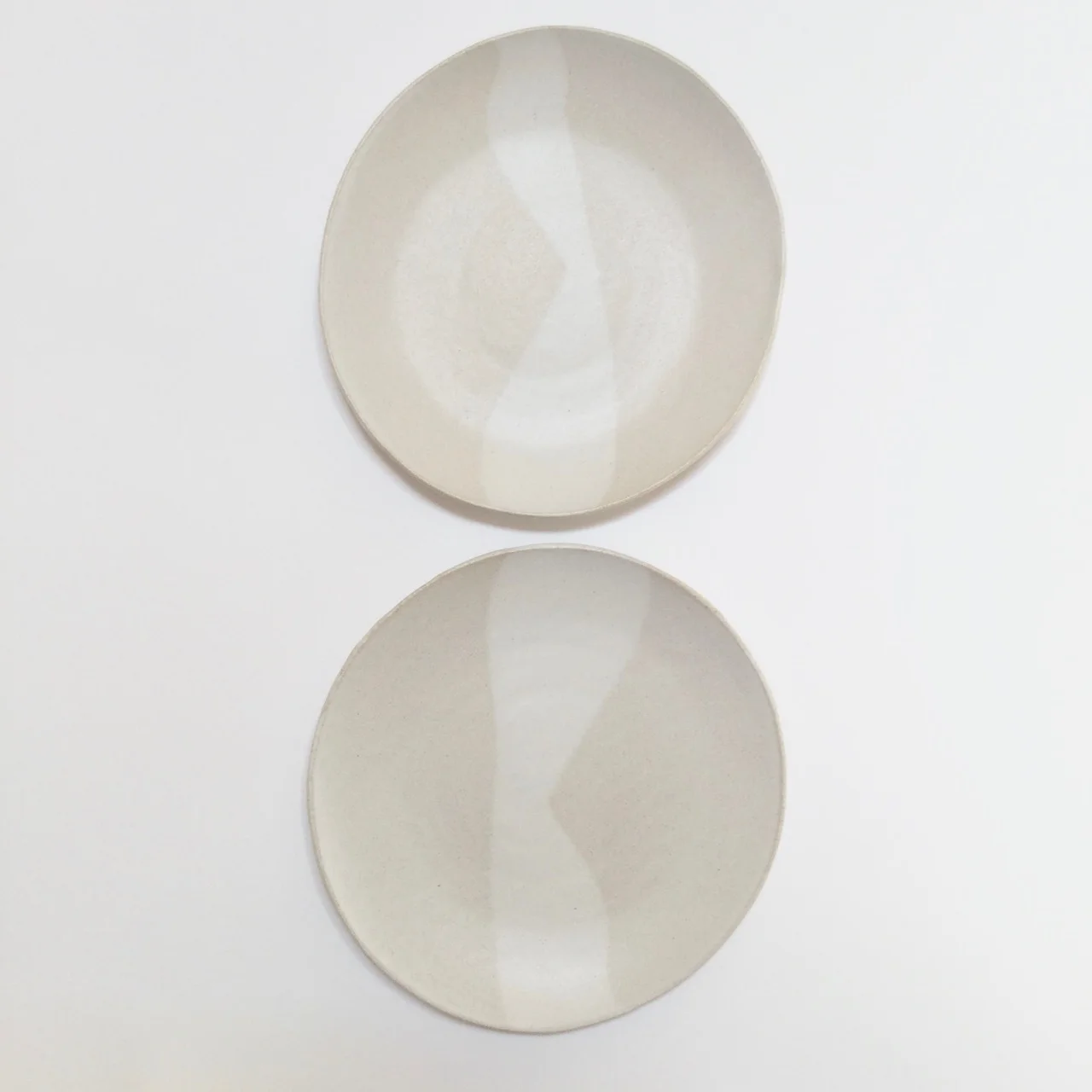 1055 Pair of white sand dinner plates top.jpg