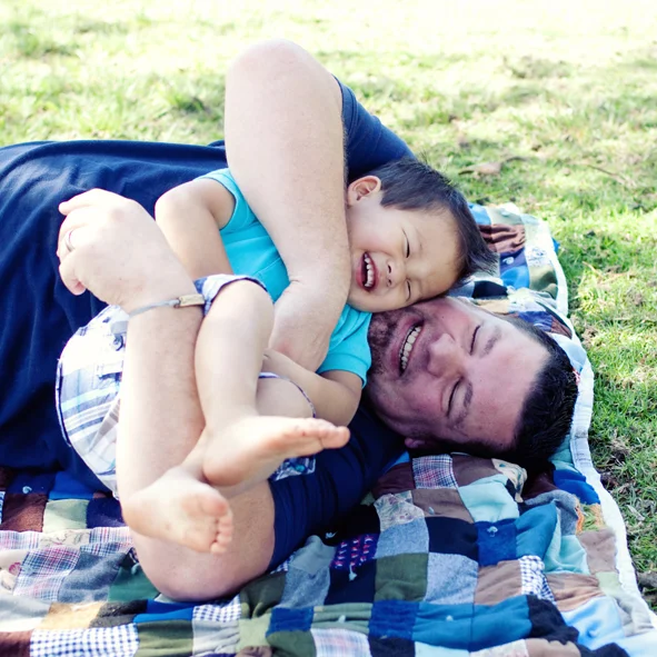 father and son bonding moment during a family day in the life photo session with The Suitcase Studio