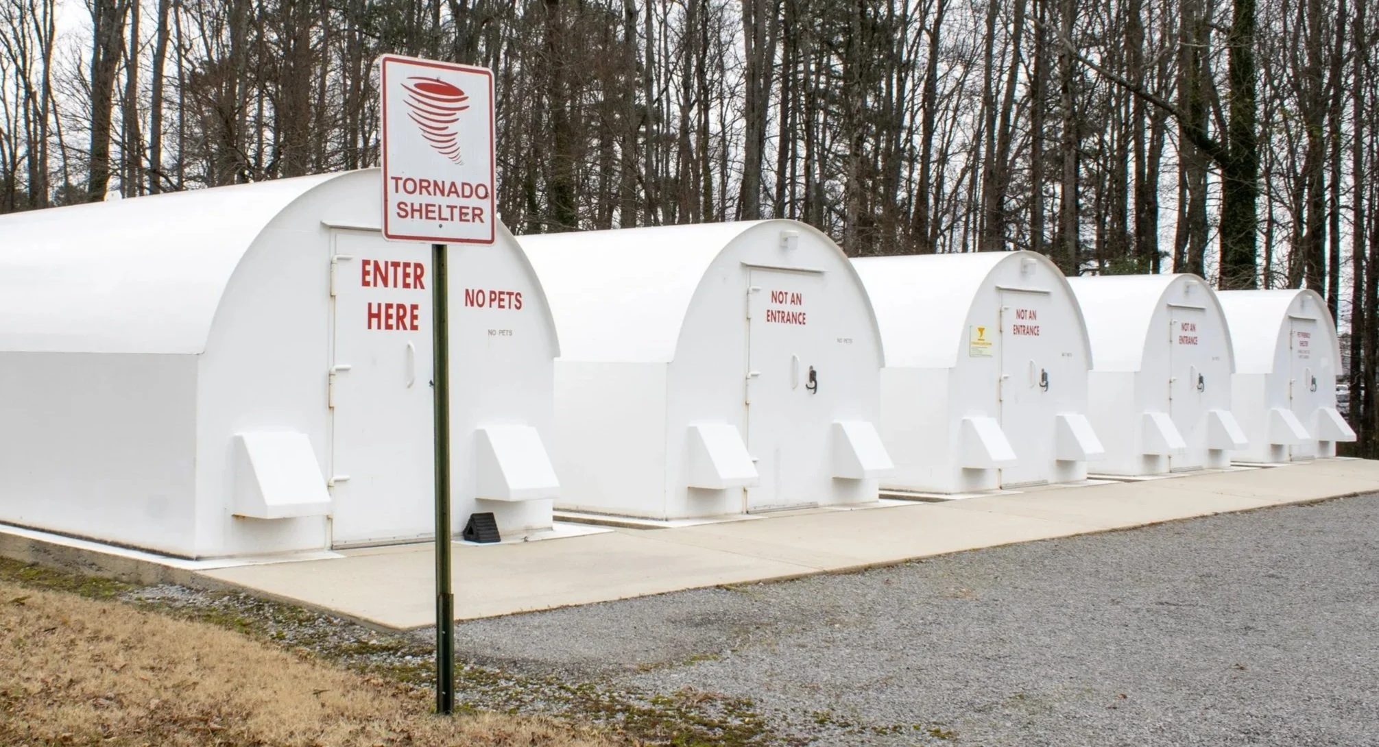 A row of white tornado shelters.