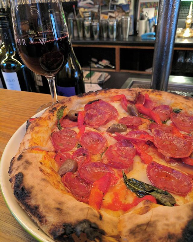 Its warm and toasty inside with a salami pizza and sangiovese combo.