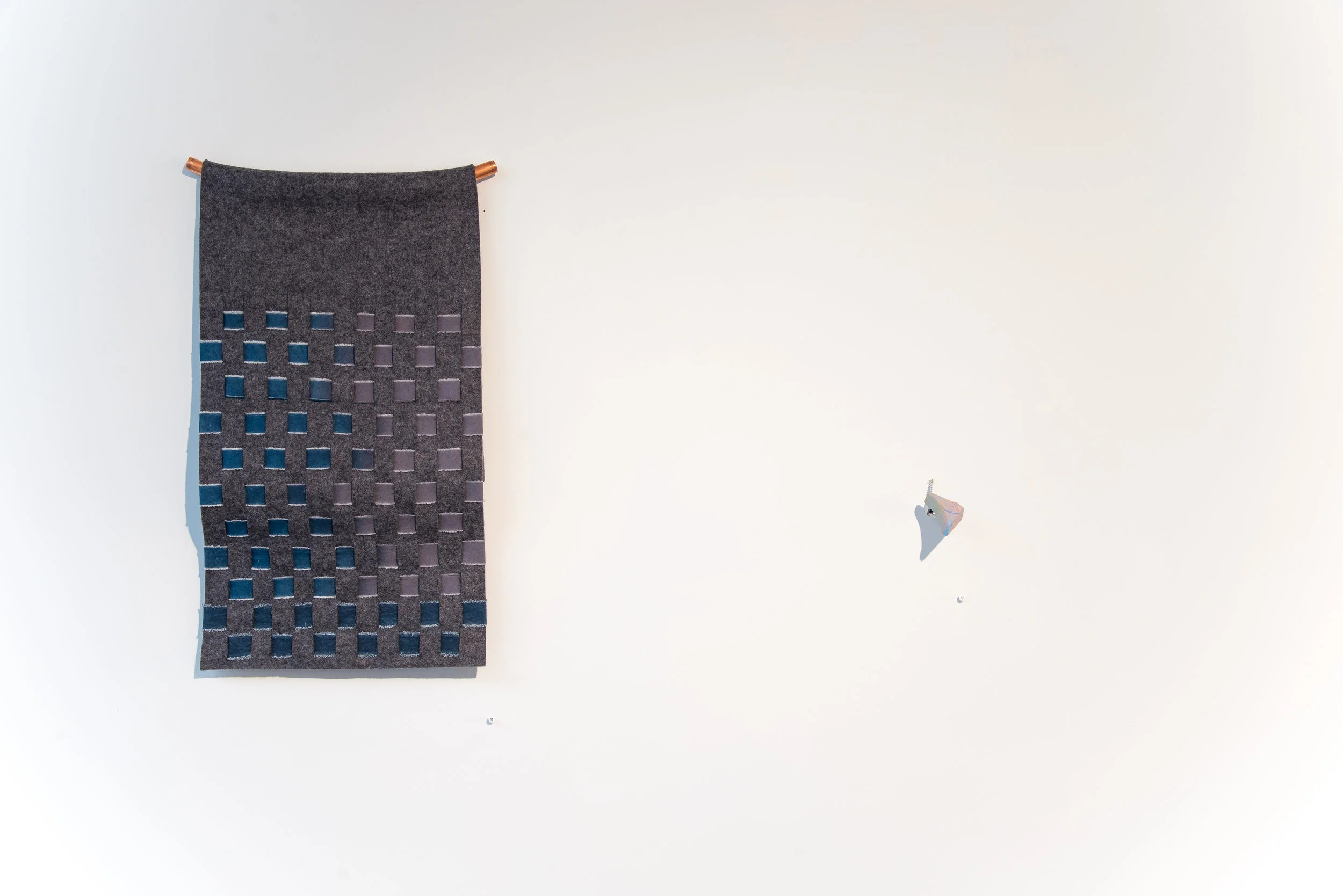 Right: Strike Cement, acrylic paint, spring loaded strike plate. 2.5"x2"x4" 2017 Left: Textiles by Megan Mesloh Photo Credit: Jason Horvath