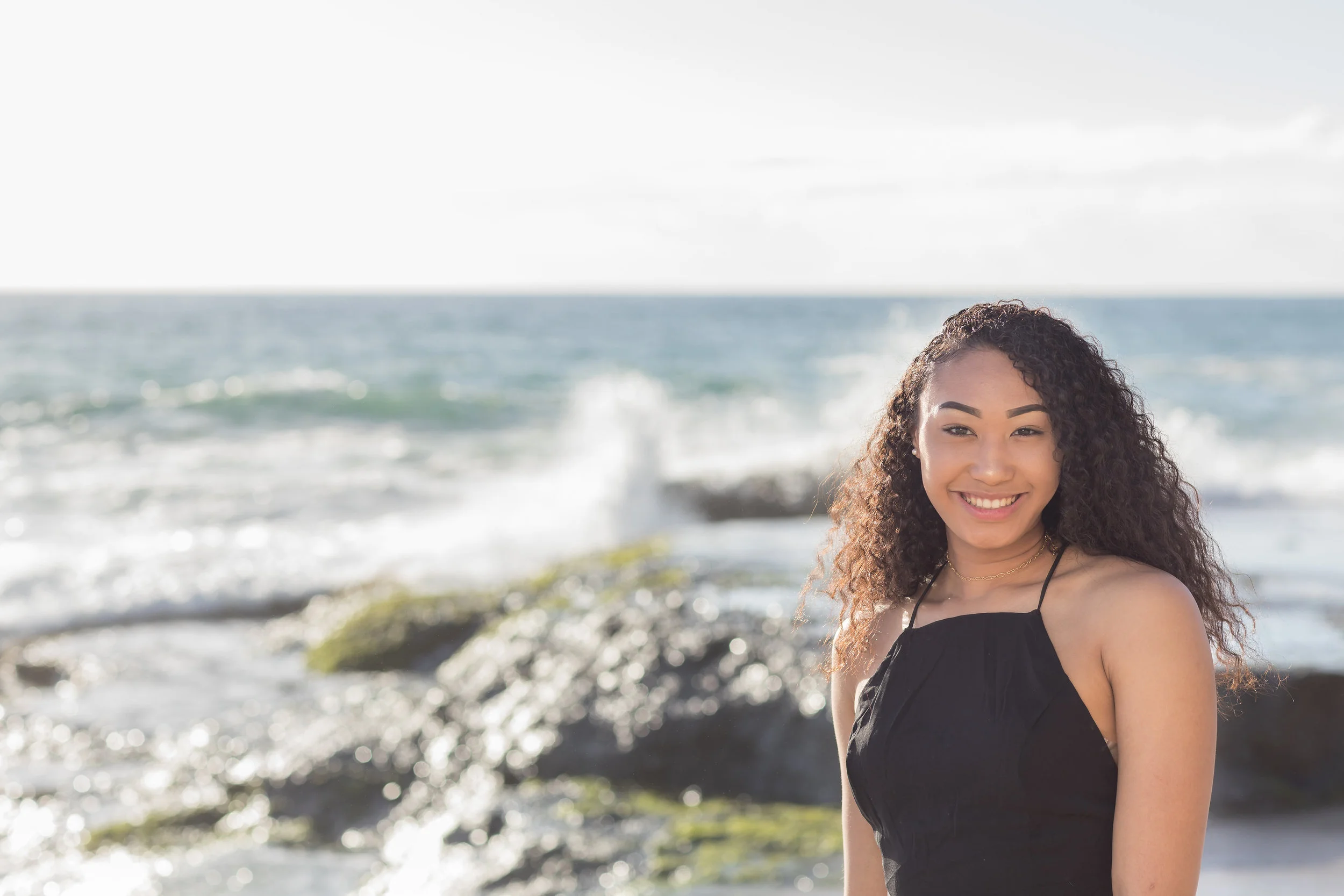 Senior female at beach with waves crashing in the background.jpg