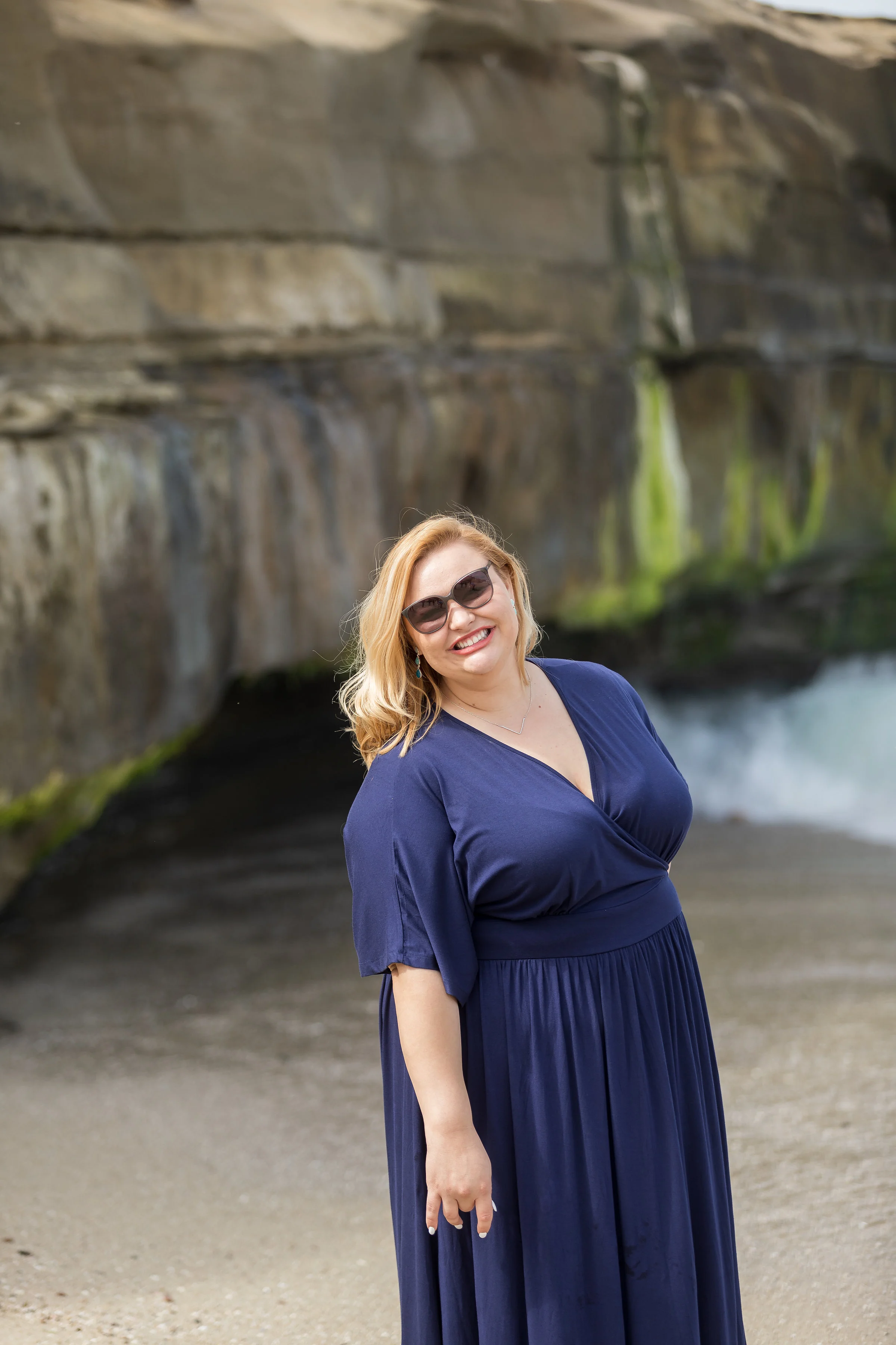 Beautiful woman in a blue maxi dress on the beach with sunglasses.jpg
