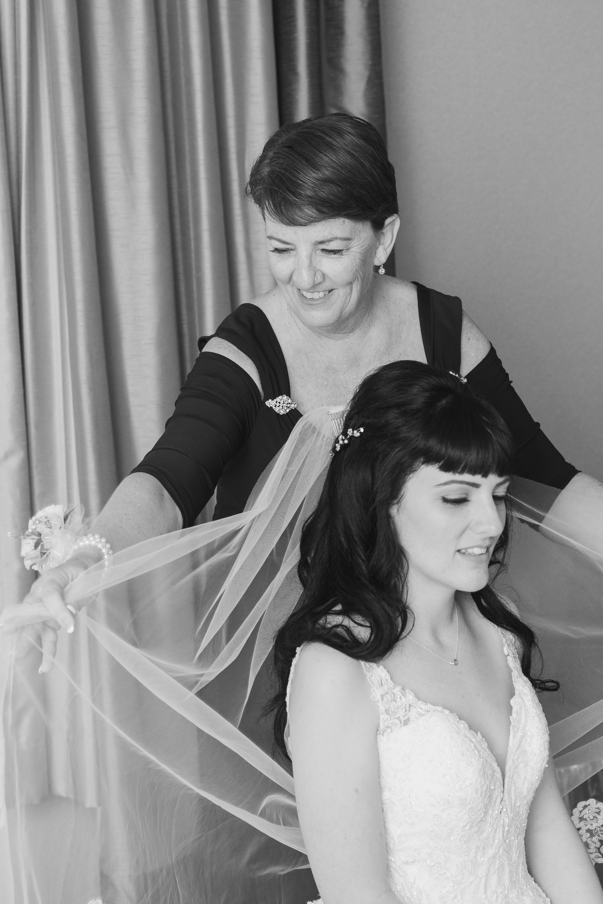 Photo of mother fixing veil of bride during getting ready.jpg