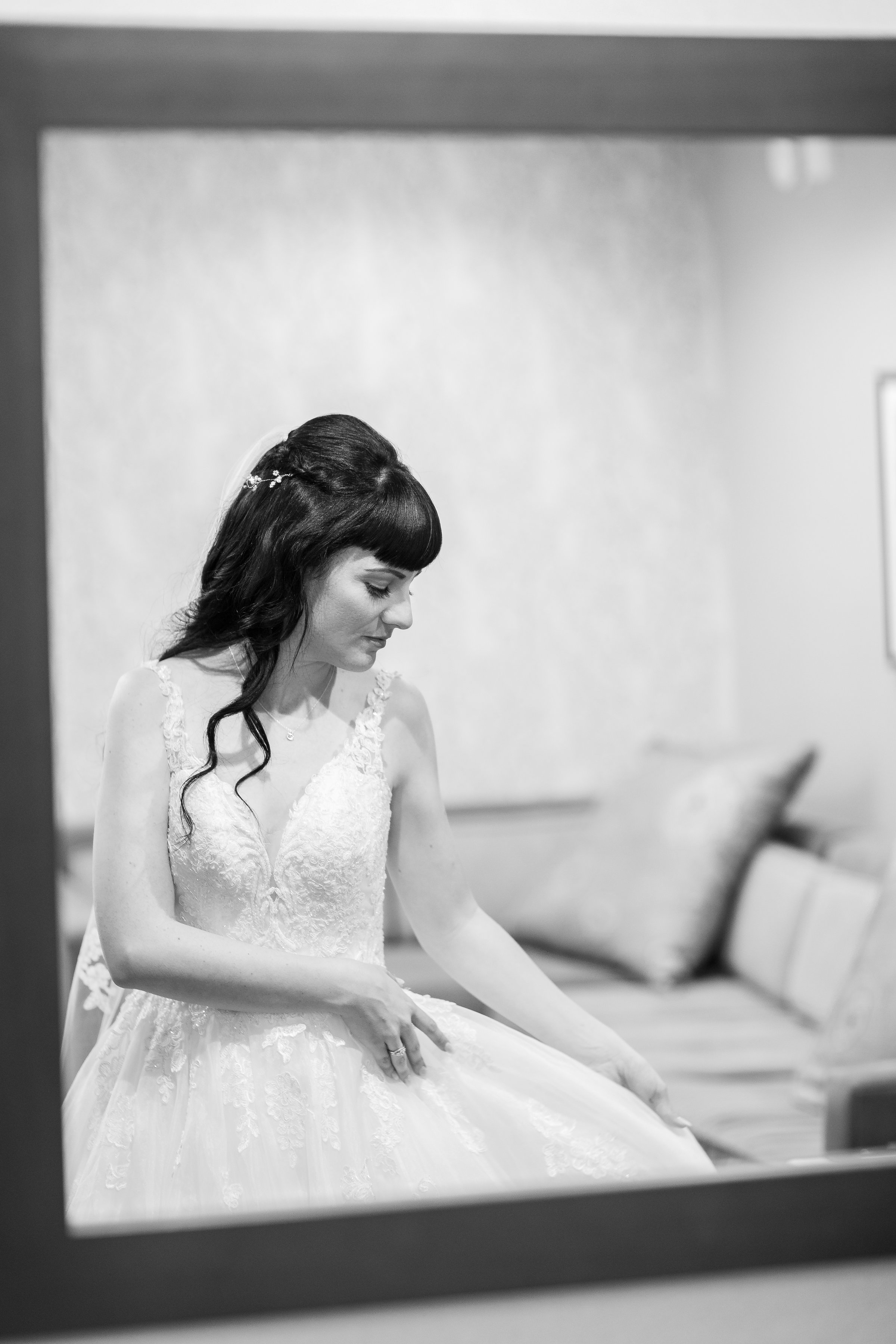 Photo of Bride fixing wedding dress while getting ready.jpg