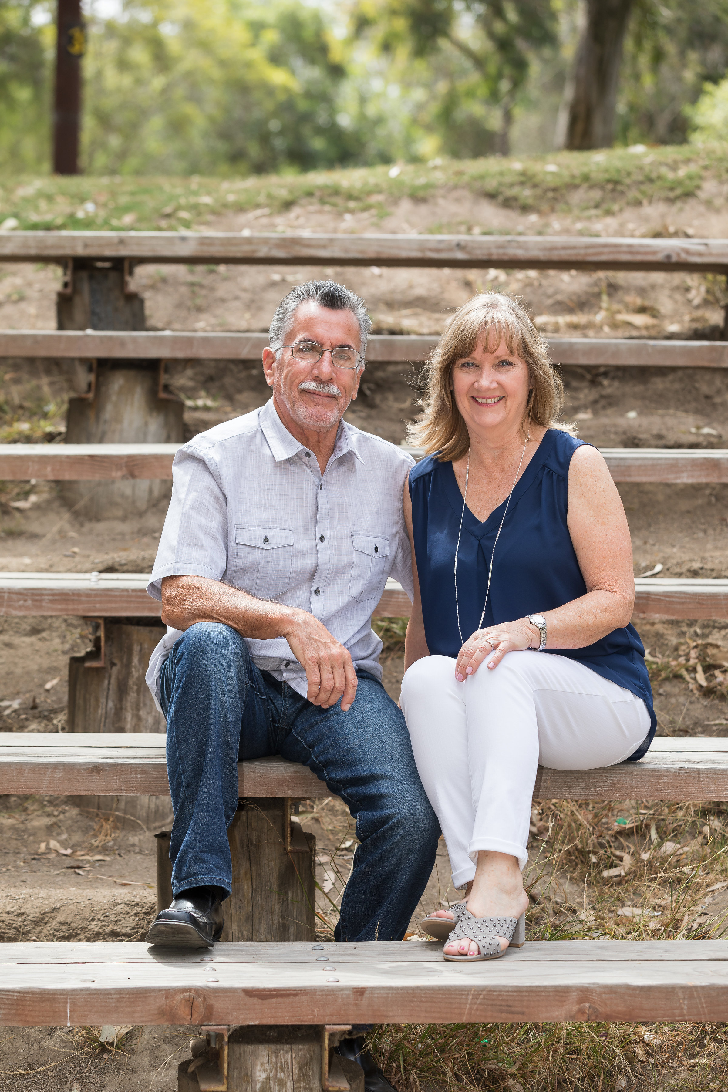Photo of husband and wife sitting on the steps in HB park.jpg