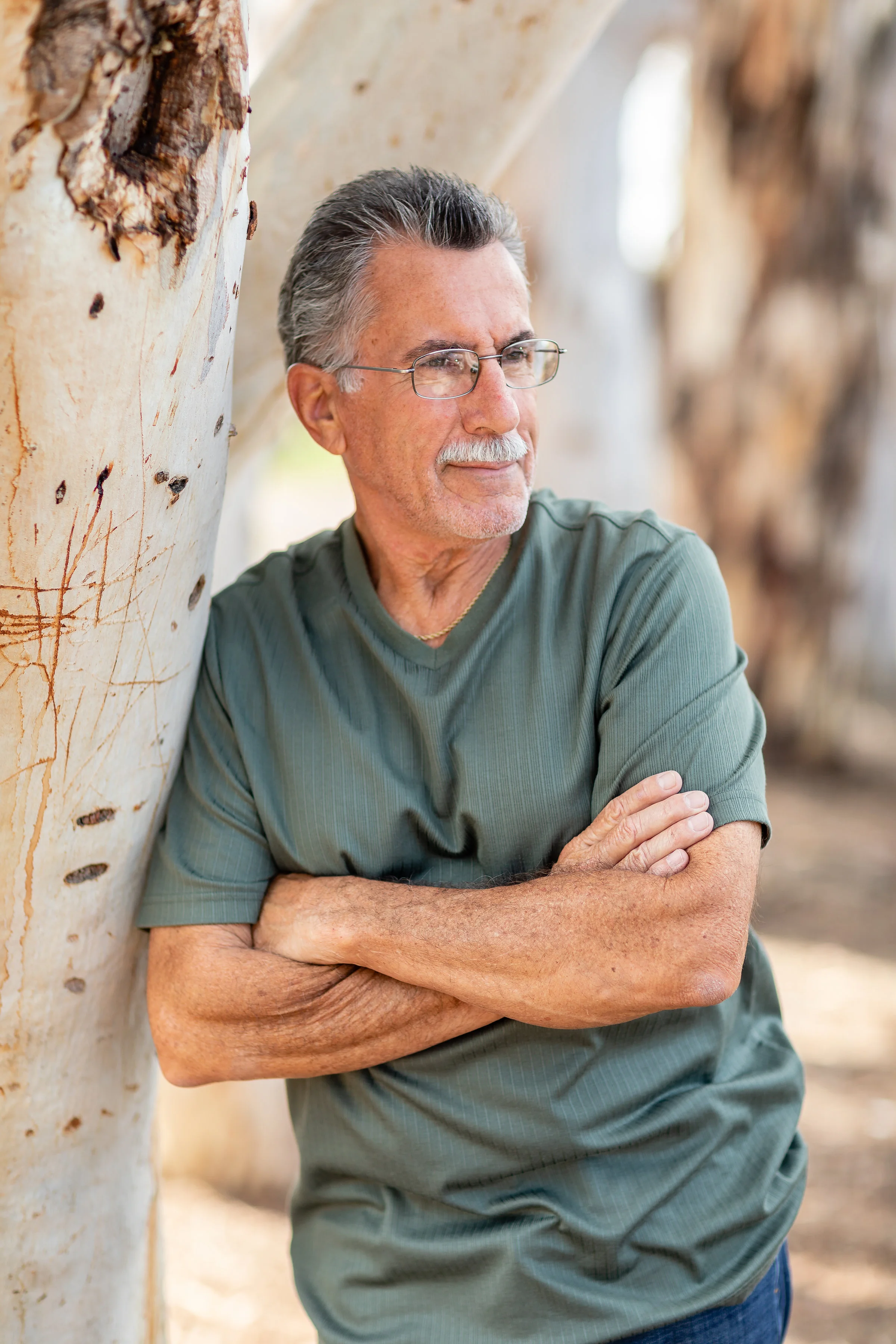Lifestyle portrait of father leaning against an HB park tree - male posing ideas.jpg