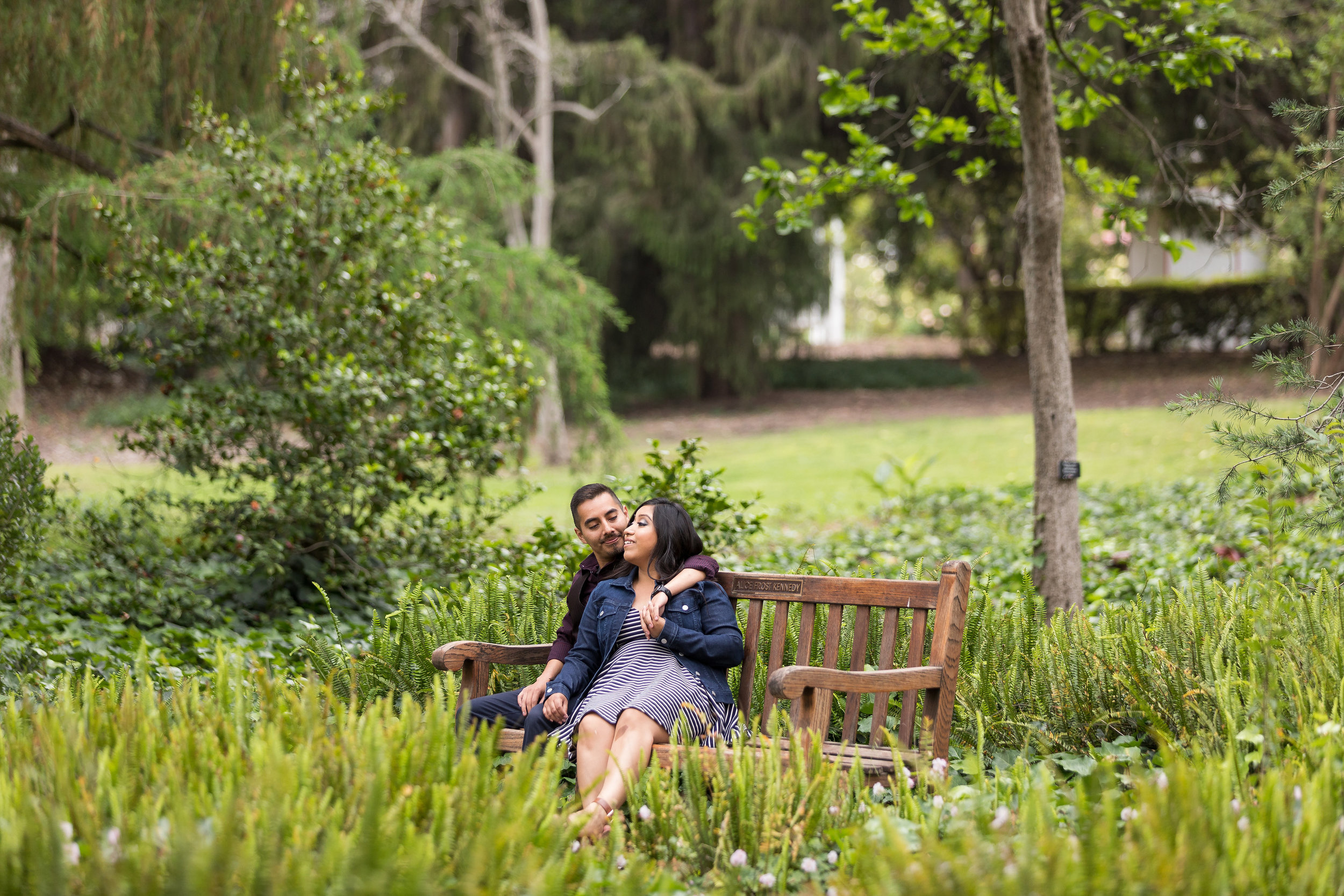 Engaged Couple sitting on a park bench.jpg
