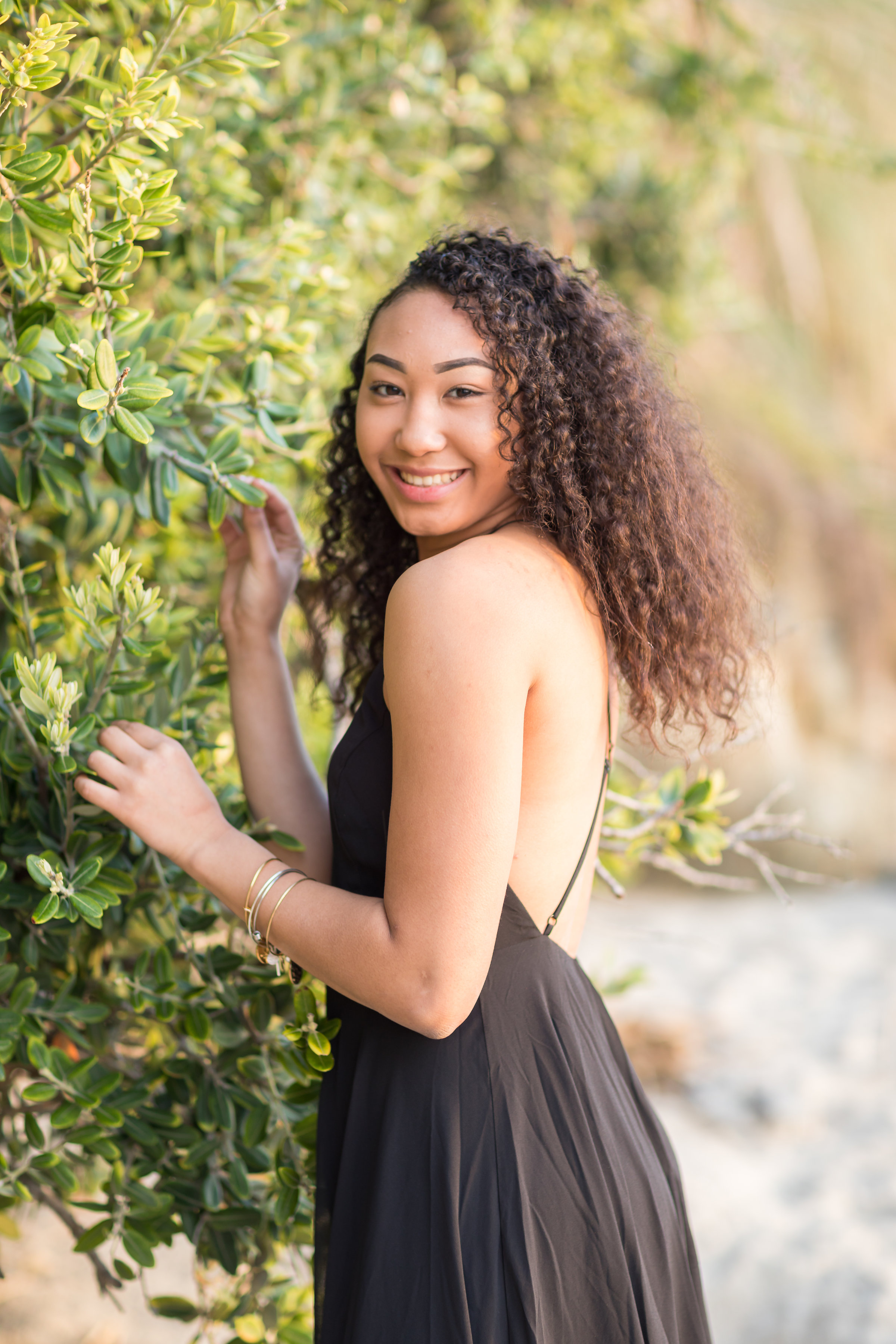 Female Senior near beach green foliage portraits in Laguna.jpg