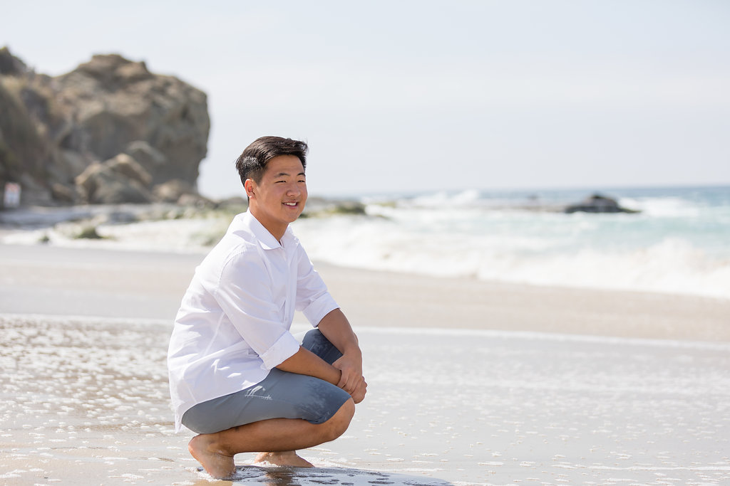 Male senior kneeling in sand at Laguna Beach.jpg