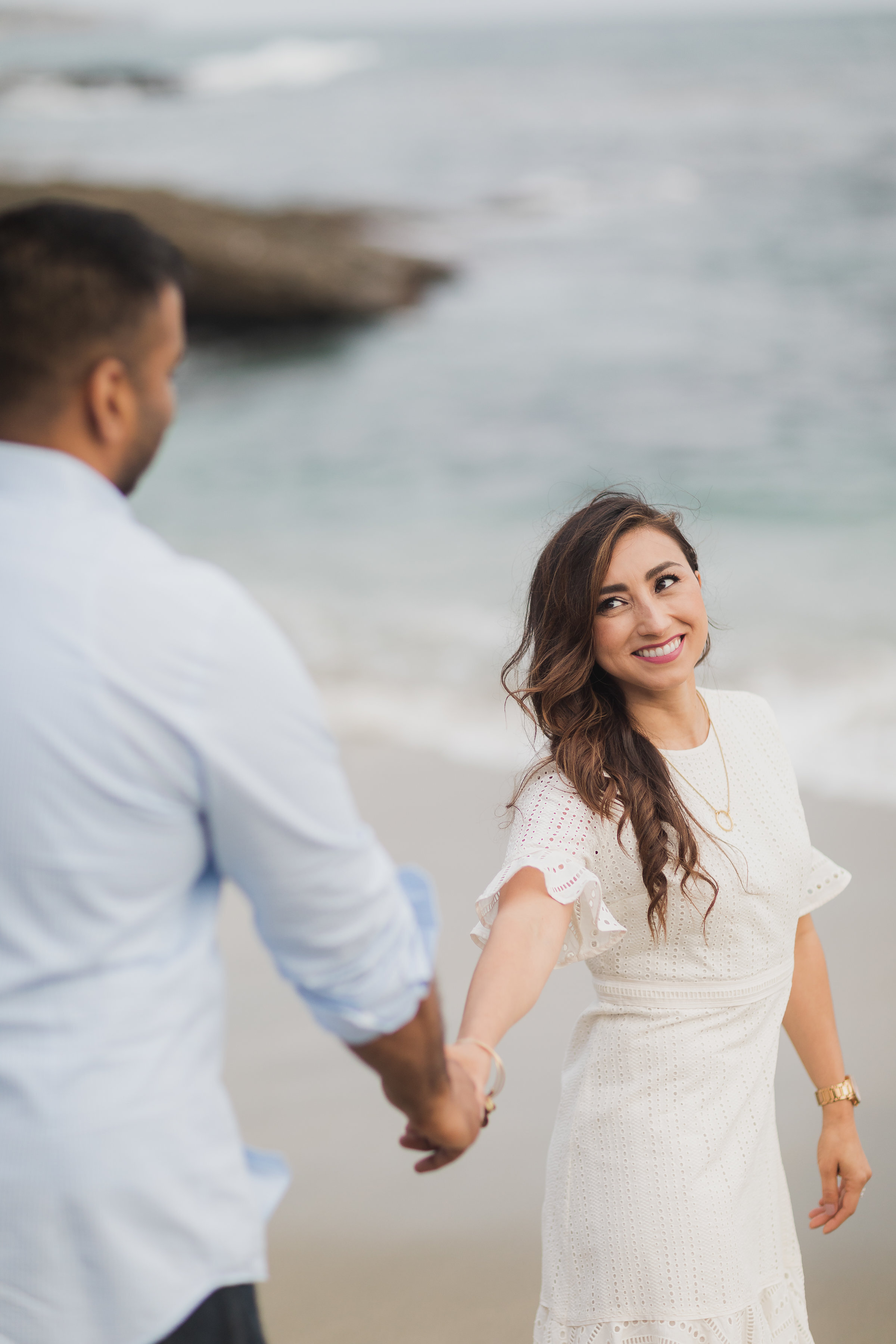 Engagement Photo Session of Girl Leading Boy at the Beach.jpg