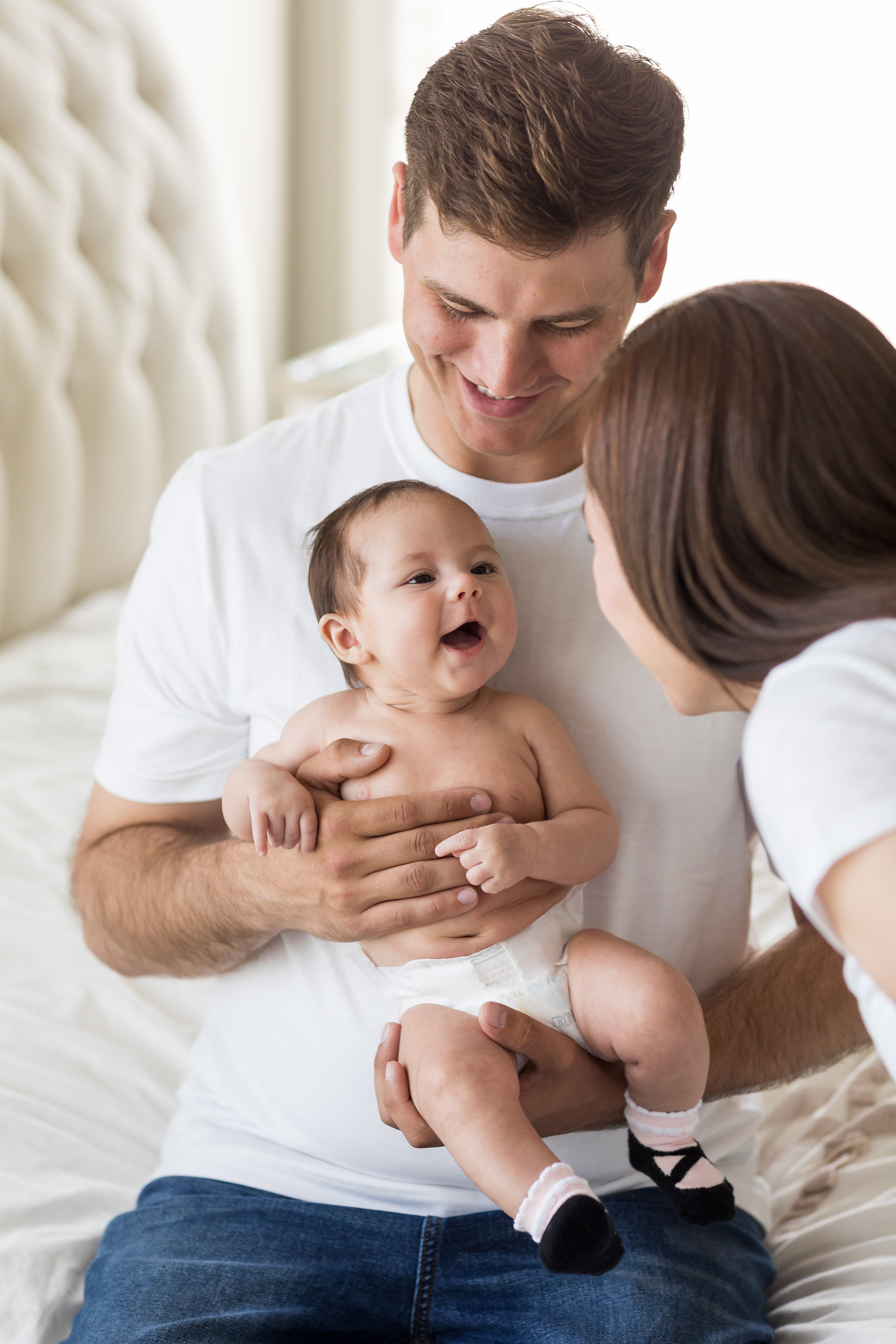 Beautiful Photo of Smiling Family with New Baby Girl at Huntington Beach Home Session.jpg