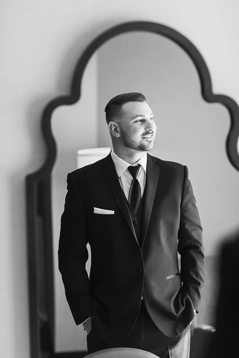 Groom portrait by window