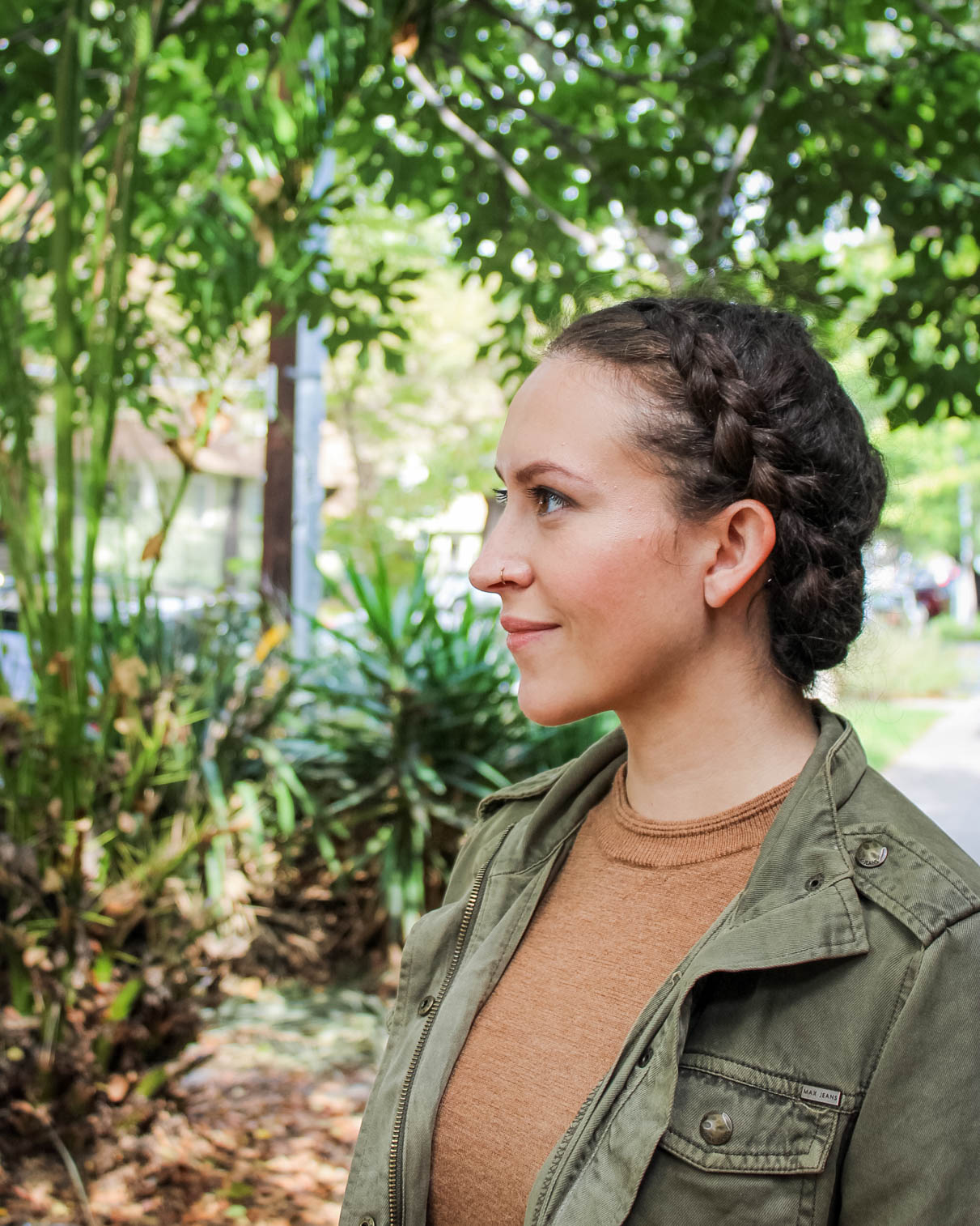 braided naturally curly updo hairstyle for a job interview