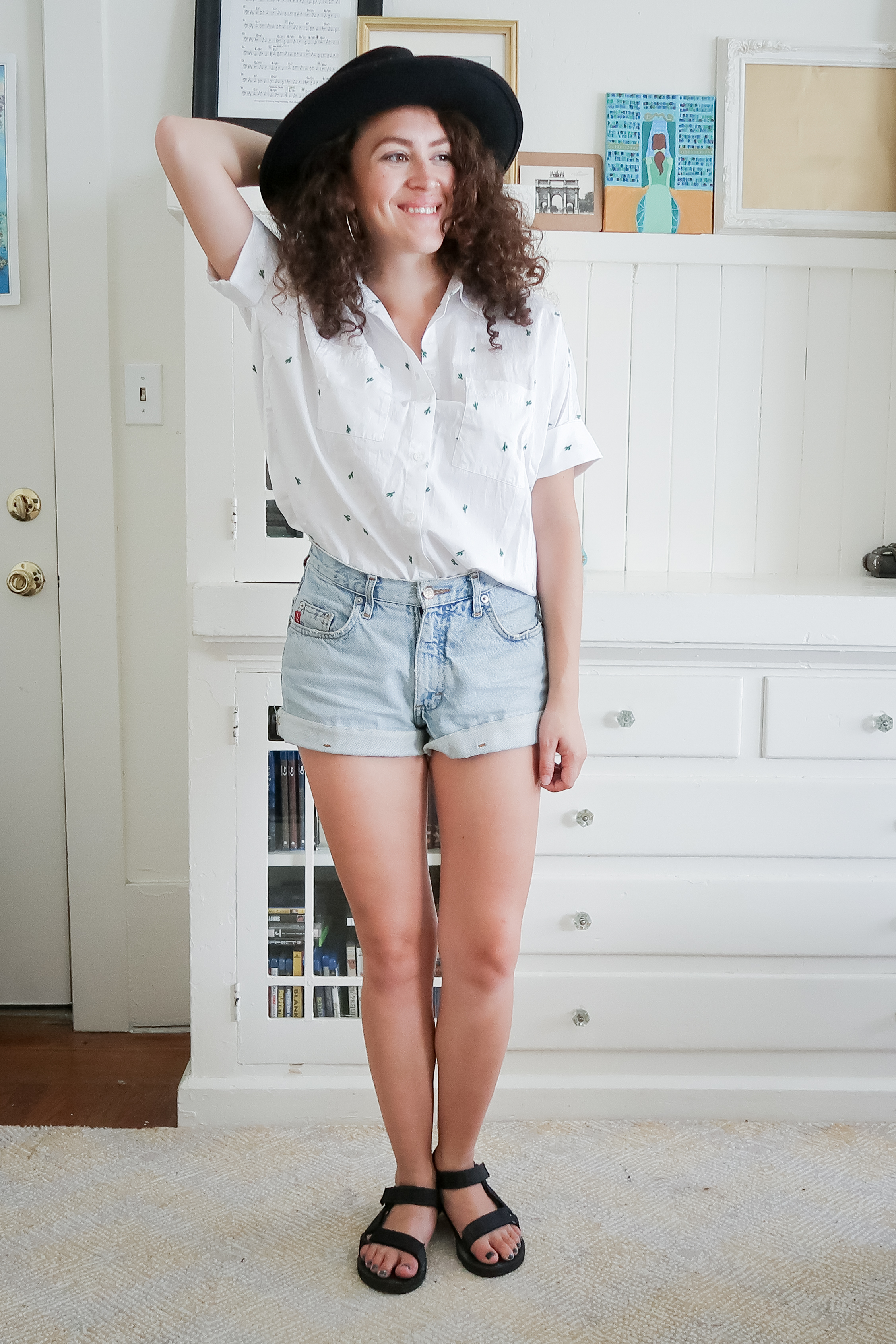 10 pieces, 10 outfits -- vintage high rise denim shorts worn with a madewell button up shirt, a black wide brimmed hat and teva original universal salndals
