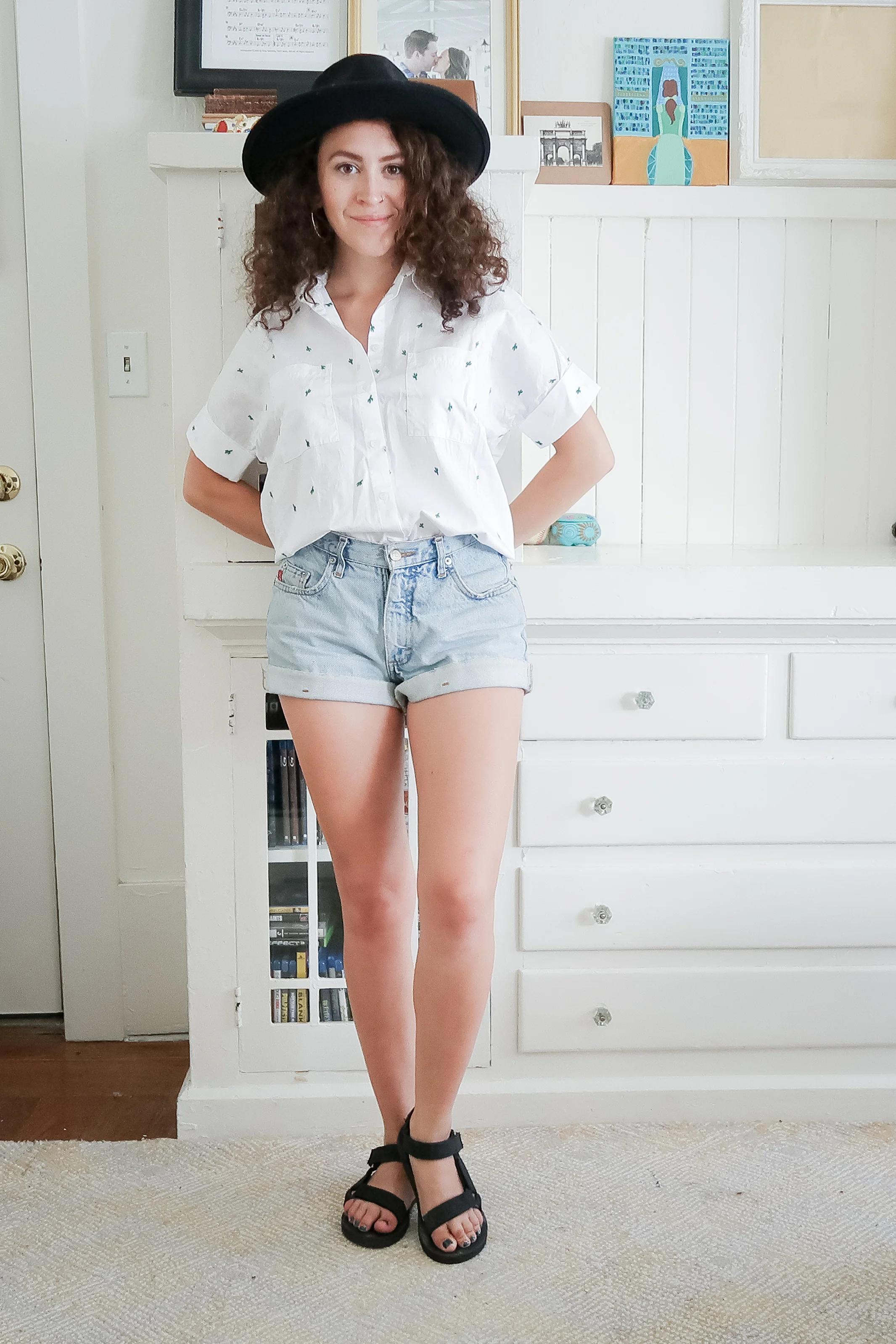 10 pieces, 10 outfits -- vintage high rise denim shorts worn with a madewell button up shirt, a black wide brimmed hat and teva original universal salndals