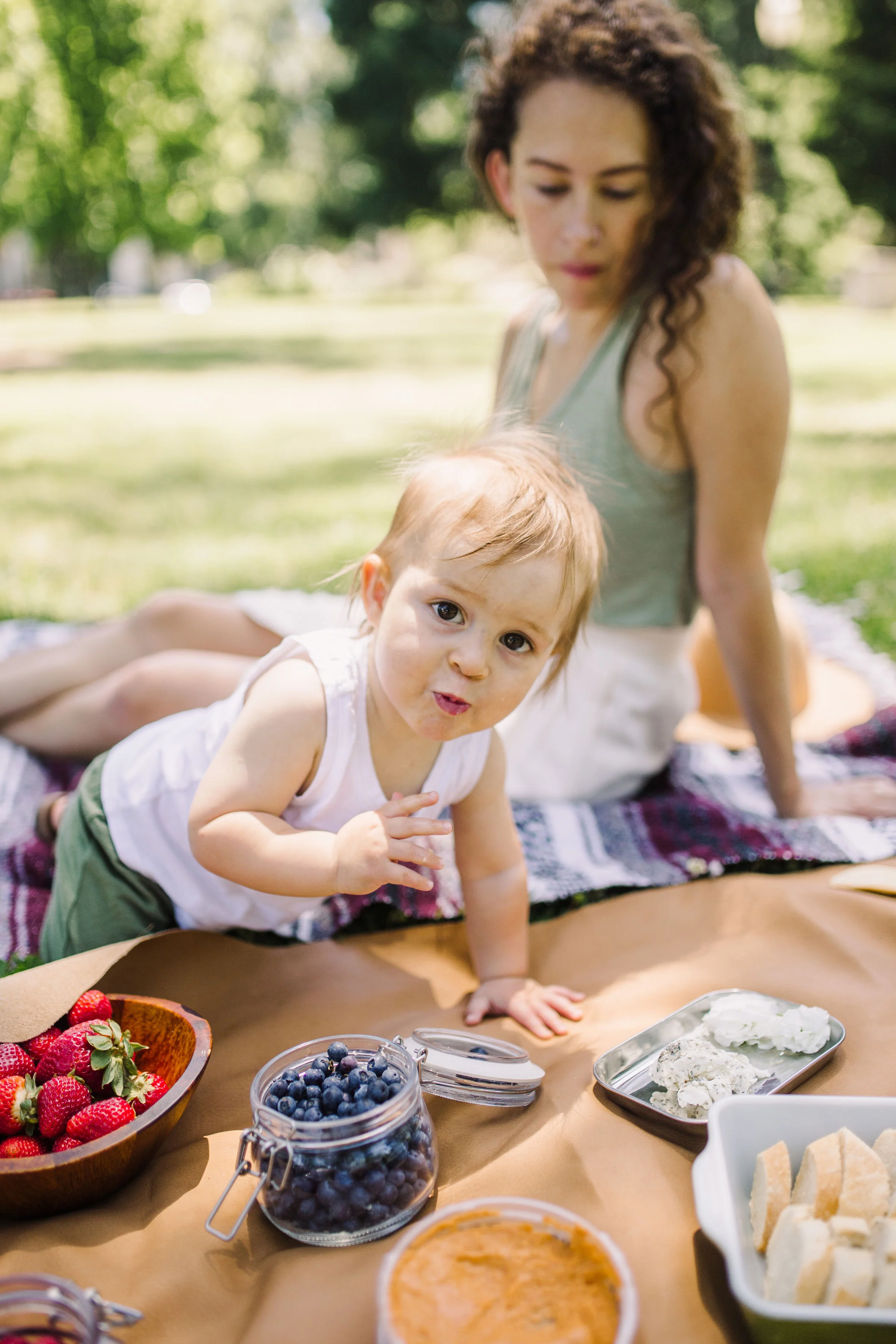 low waste summer picnic in the park using our gathre mat in saddle - sacramento, california - tinted-green.com - photos by sarah akiyama - wearing sage green tank top from madewell and button up midi skirt from urban outfitters purchased secondhand on poshmark