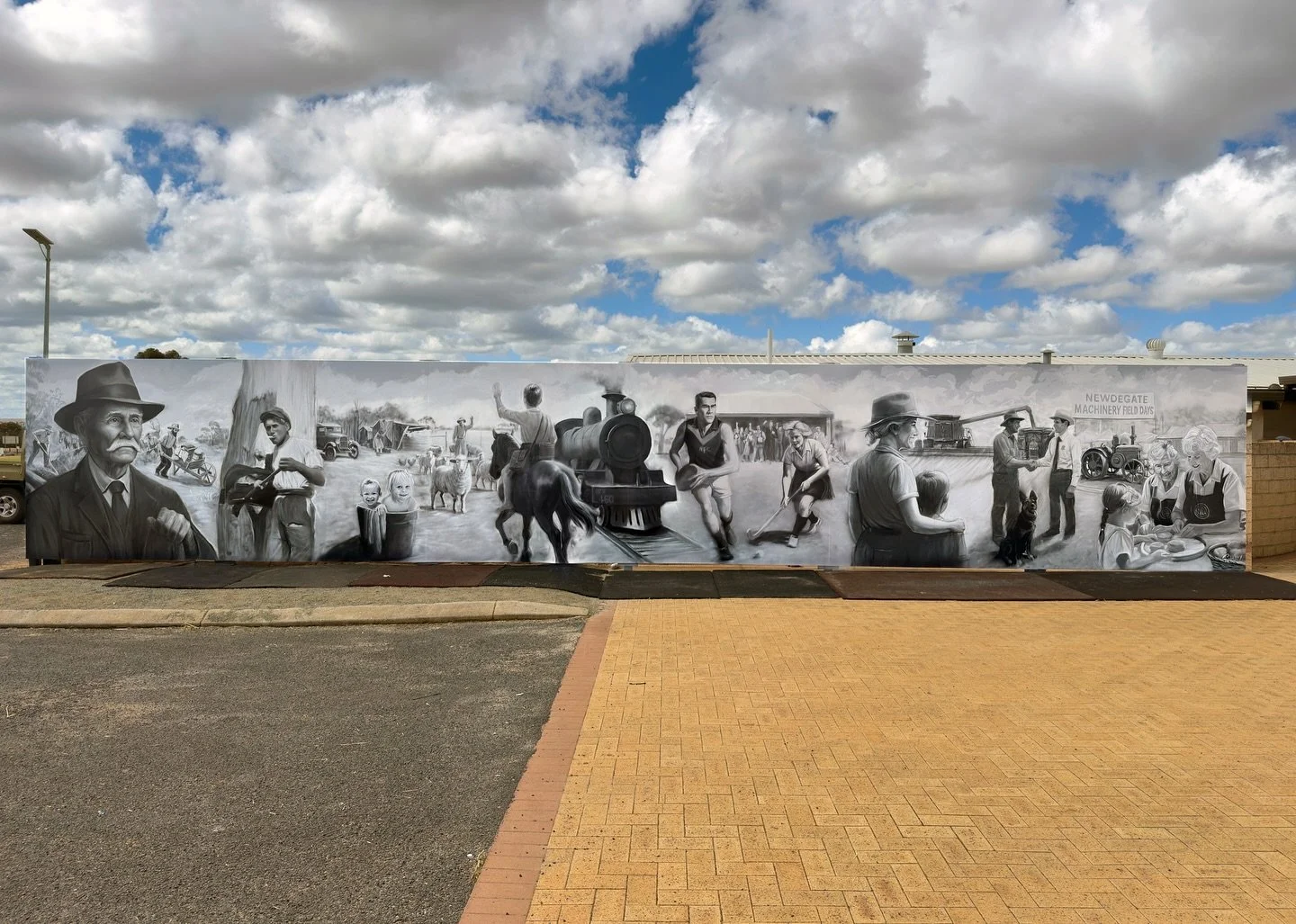 Newdegate Machinery Field Days Mural
This mural tells the journey of Newdegate — from John Holland cutting the track through the bush, to the grit of early life in the 1920s, the arrival of the train that opened the town to the wider world, an