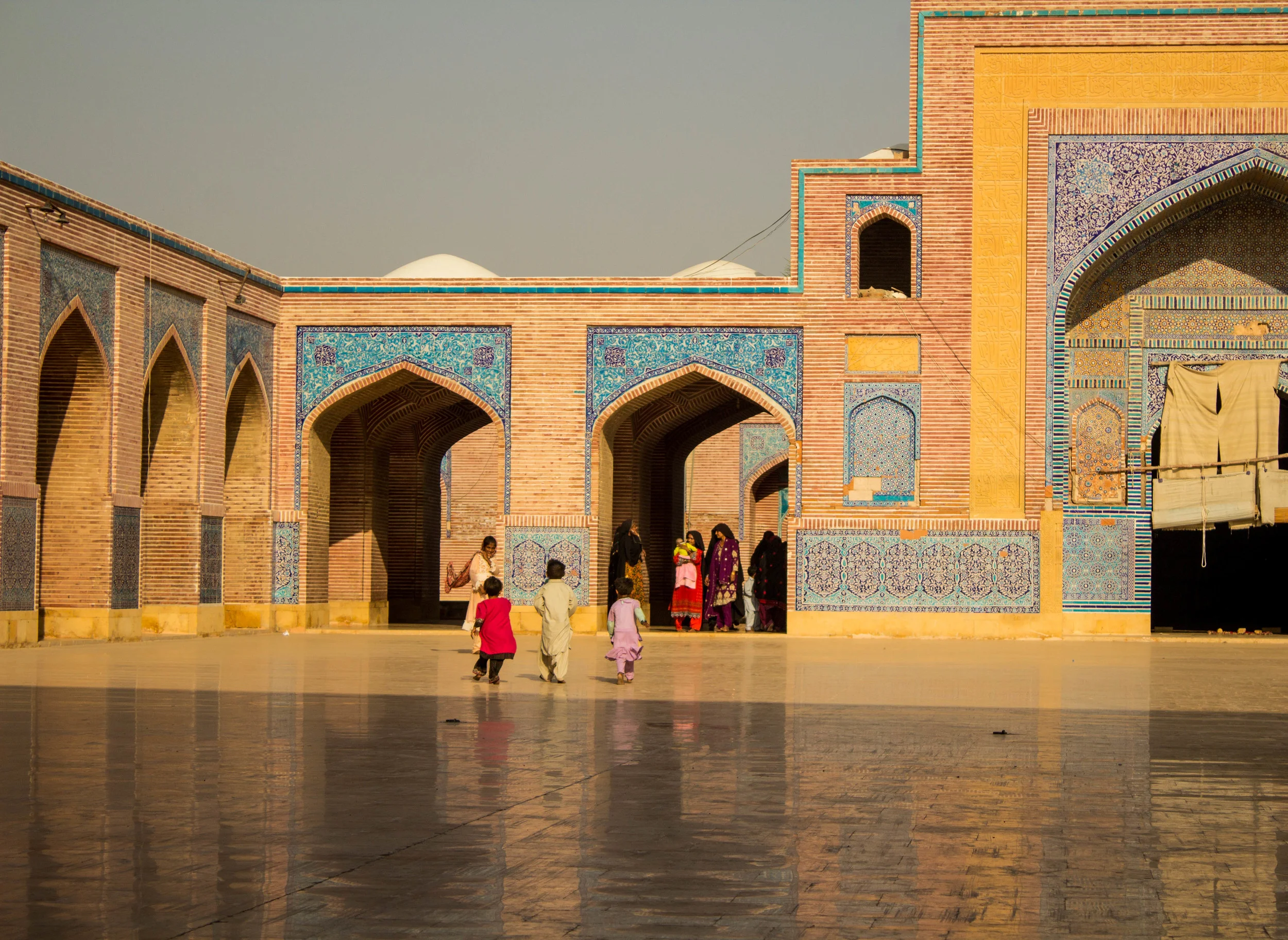 Children run through the courtyard of the Shah Jahan Masjid as their families come through the archway from the ablution (ritual washing) area (photo by Olivia Curl)
