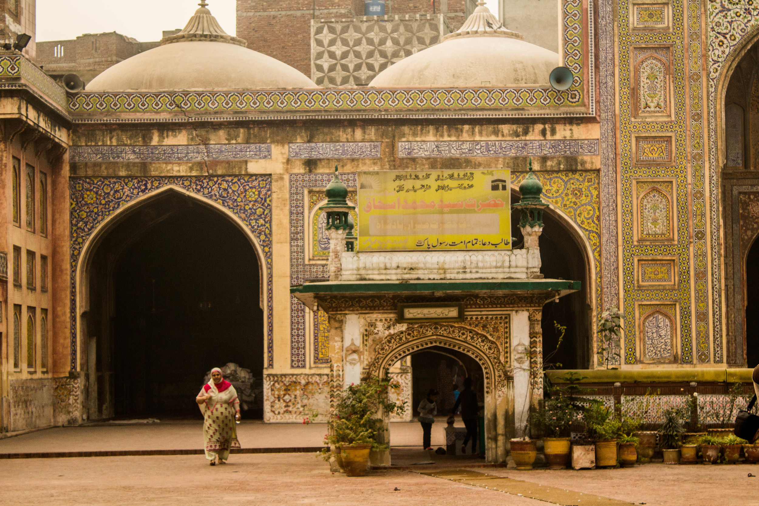 A woman strolls through the inner courtyard of the Wazir Khan Masjid inside Old Lahore. 