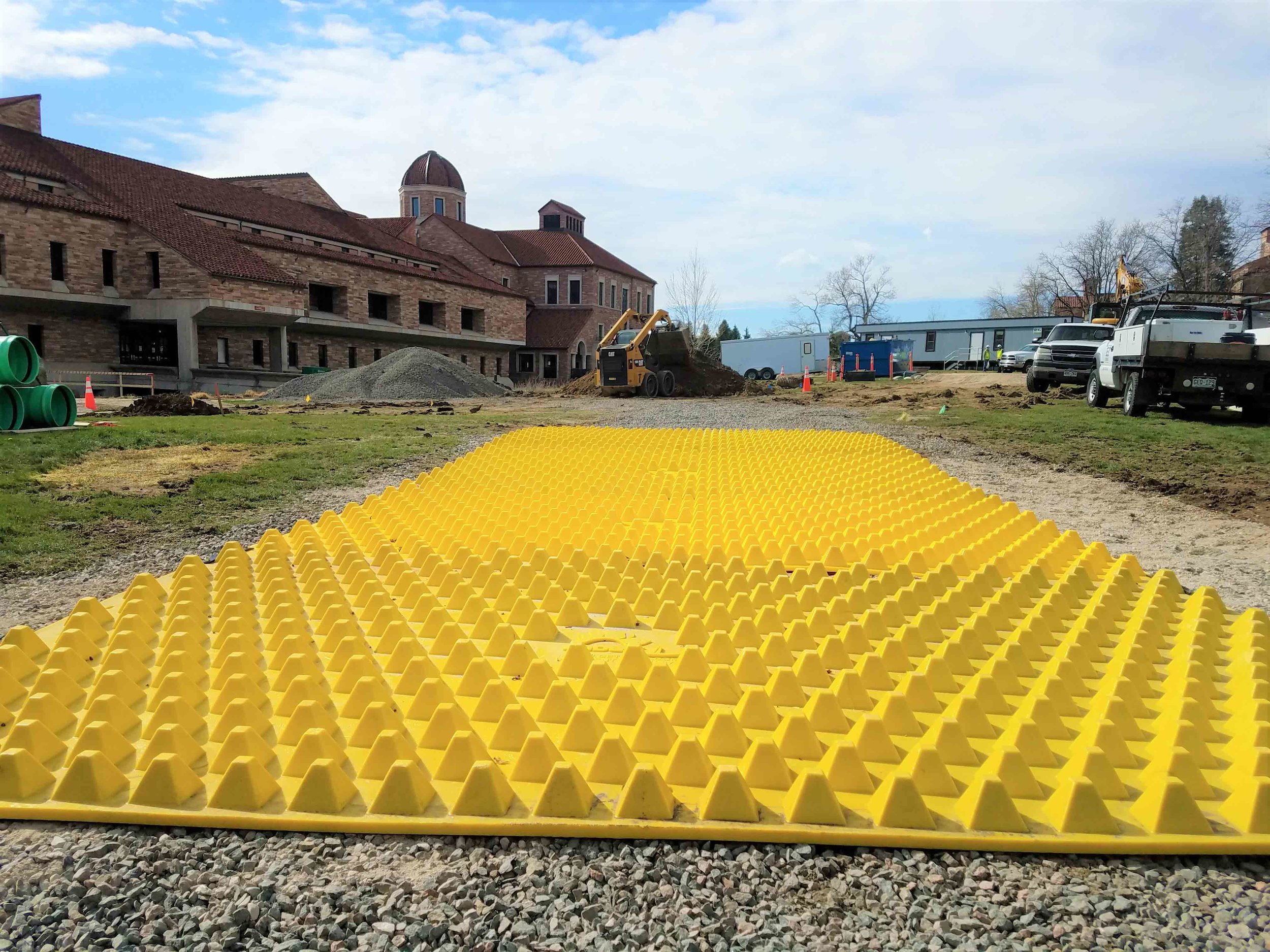 FODS_CUEngineeringBusiness_expansionProjects_FODSTrackoutControlSystem_ConstructionEntranceConstructionExit_mudMats_yellowPlasticConstructionMats_wheelwash_rumbleGrate.jpg