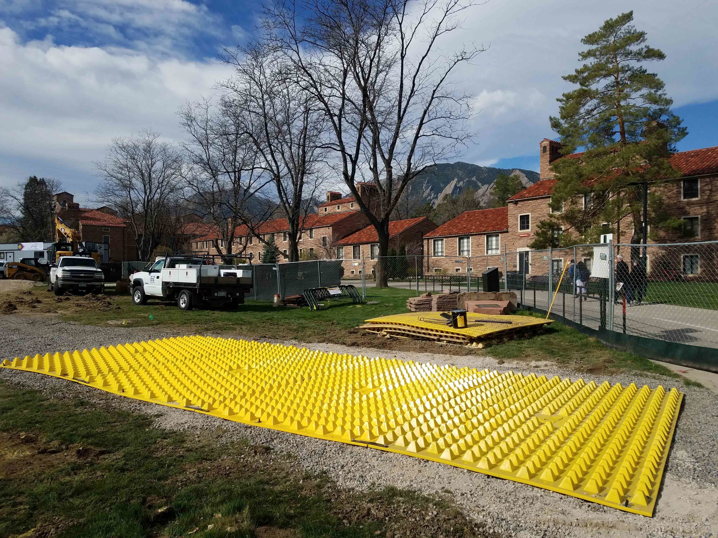 FODS_CUEngineeringBusiness_expansionProjects_FODSTrackoutControlSystem_ConstructionEntranceConstructionExit_mudMats_yellowPlasticConstructionMats_wheelwash_rumbleGrate_geotextileConstructionEntrance.jpg