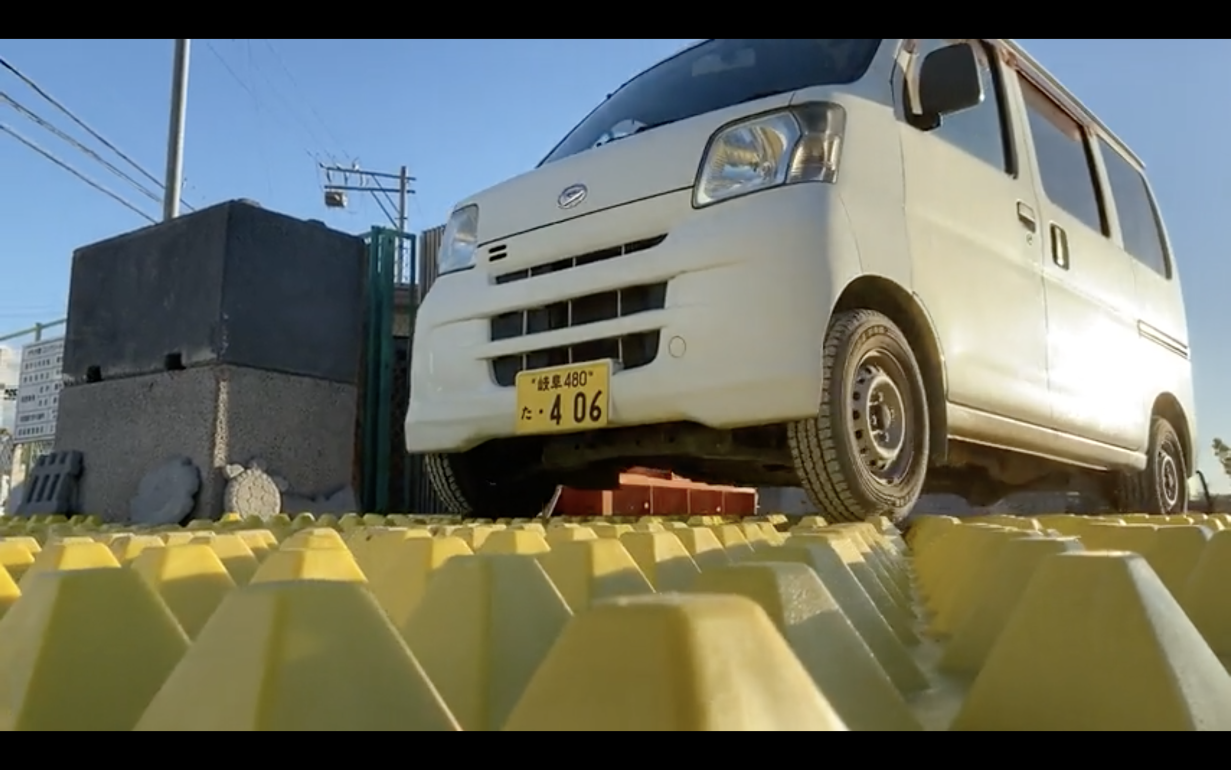 Small-Tires-Driving-Over-Japan-Construciton-Site-Entrance-Road-Vehicle-Tracking-System-Japan-Ministry-Of-The-Environment-Contain-Contaminated-Soil-Toxic-Radioactive-Sediement-Water-Quality-Construction-Entrance.png