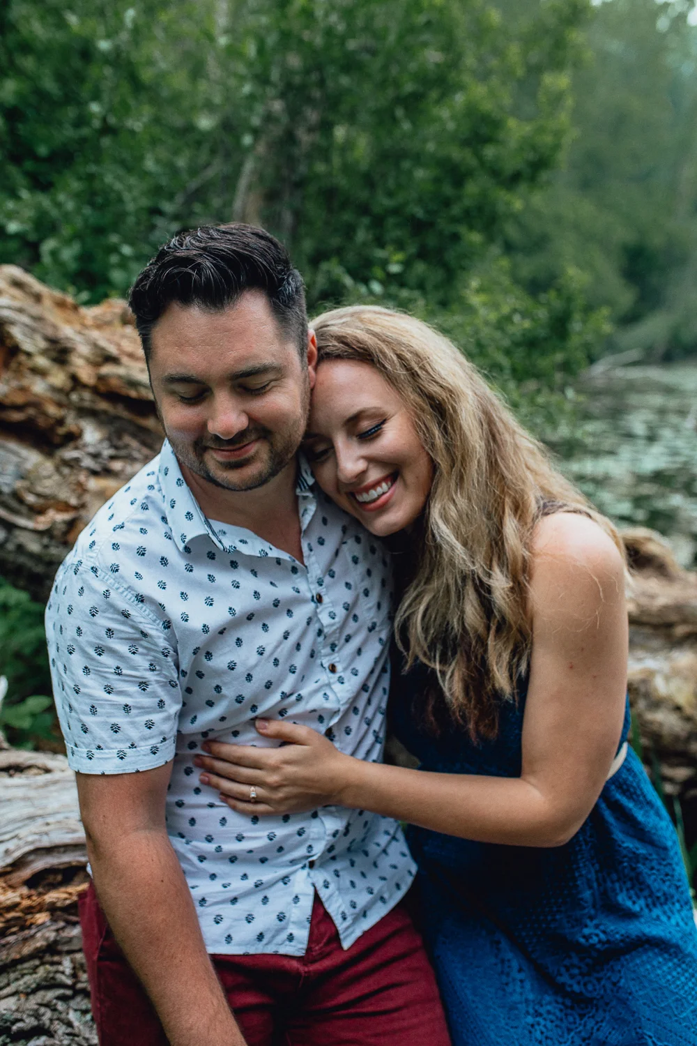 engaged-bride-and-groom-sitting-by-river.jpg