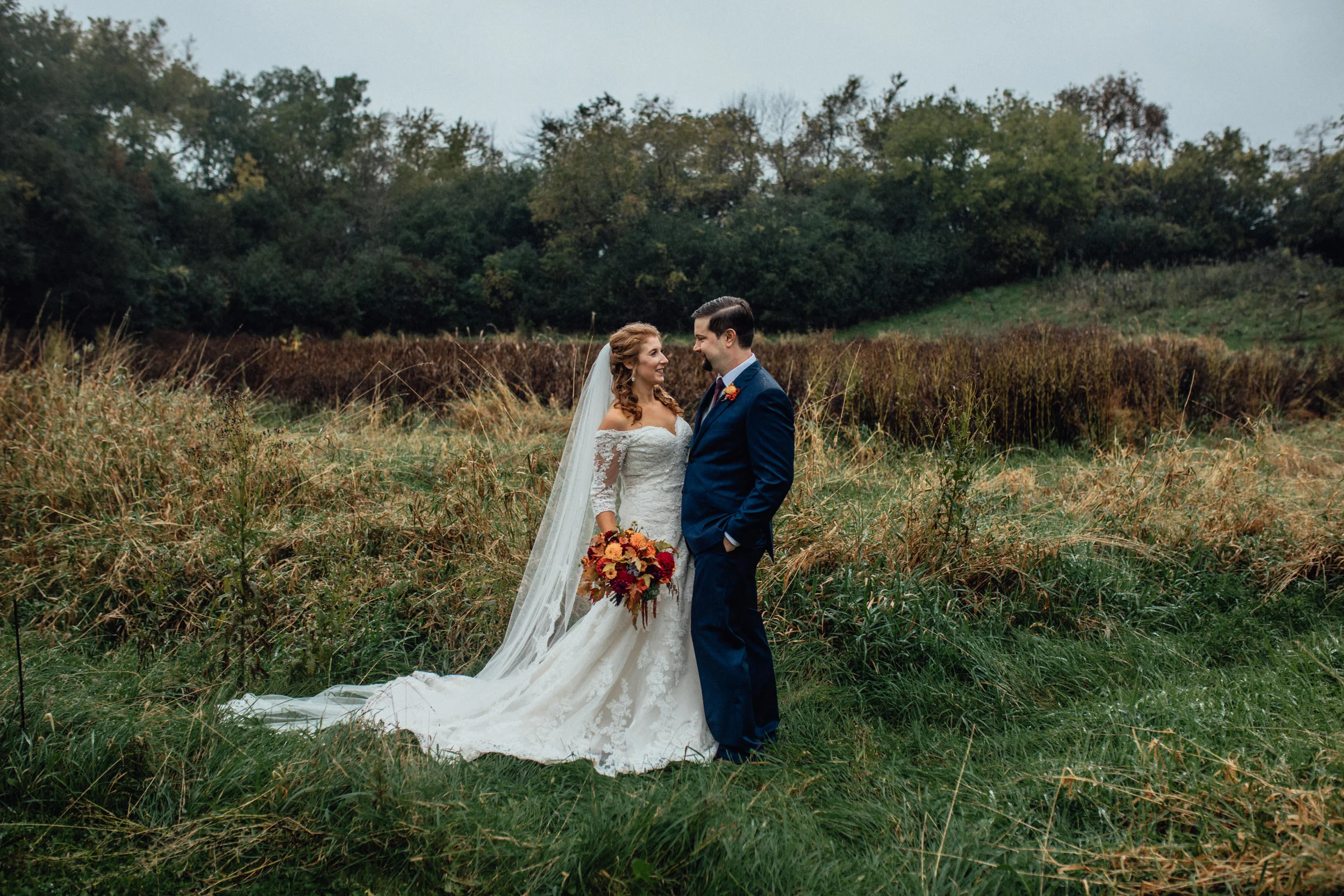 bride-and-groom-in-moody-field-portrait-at-rustic-manor-1848.jpg