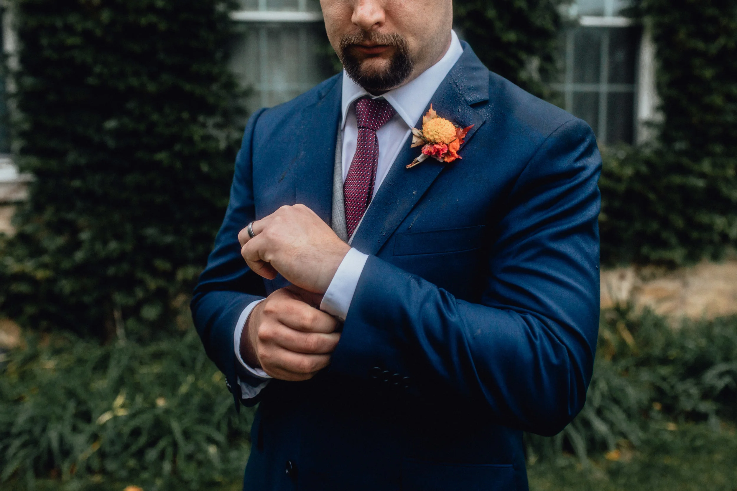 groom-buttoning-sleeve-at-rustic-manor-1848-with-ivy.jpg