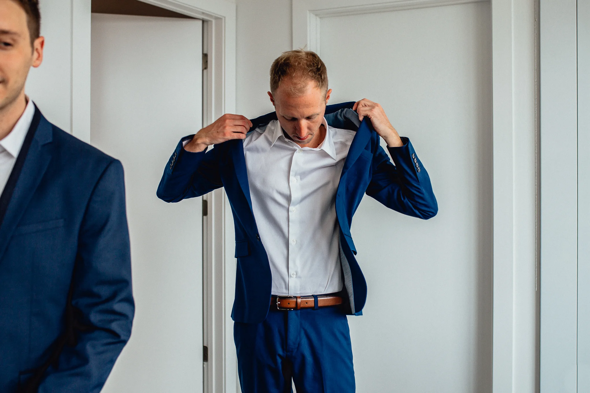 Groom-getting-ready-putting-on-coat.jpg