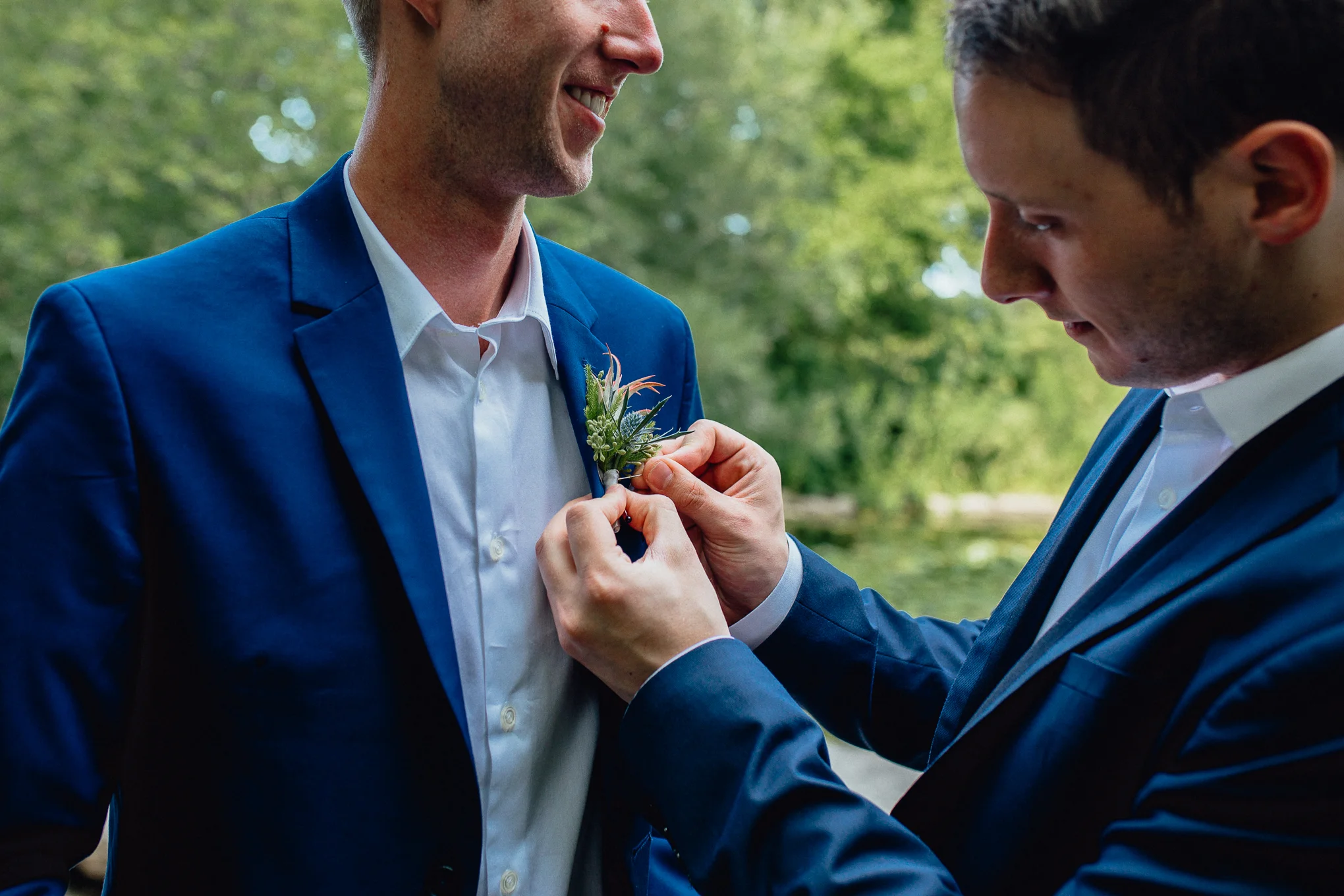 Groom-pinning-boutonniere-on-groom.jpg