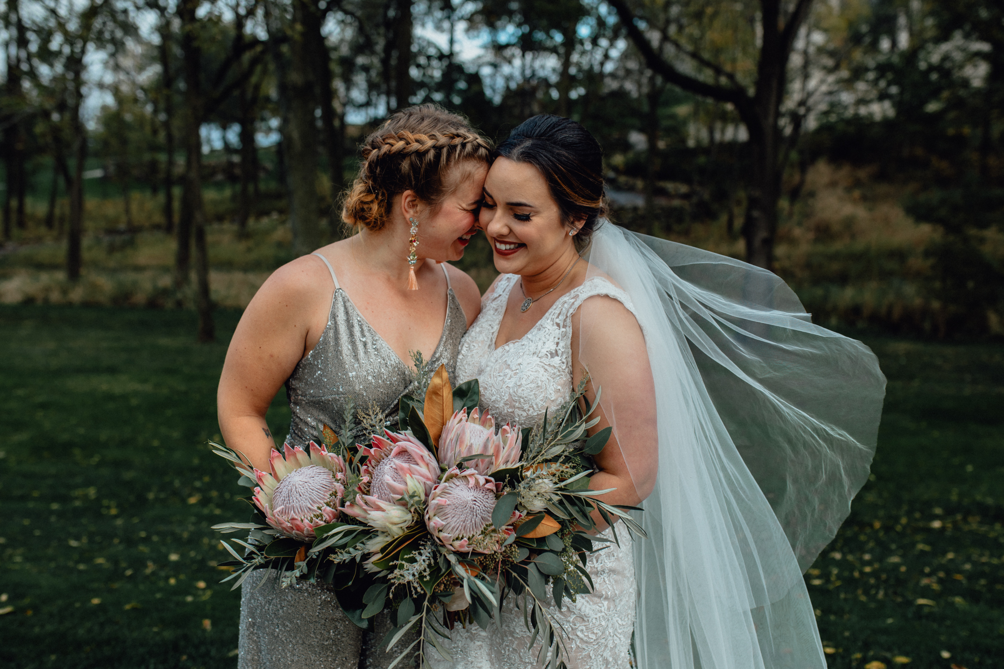 bridesmaid-smiling-with-bride-in-grass.jpg