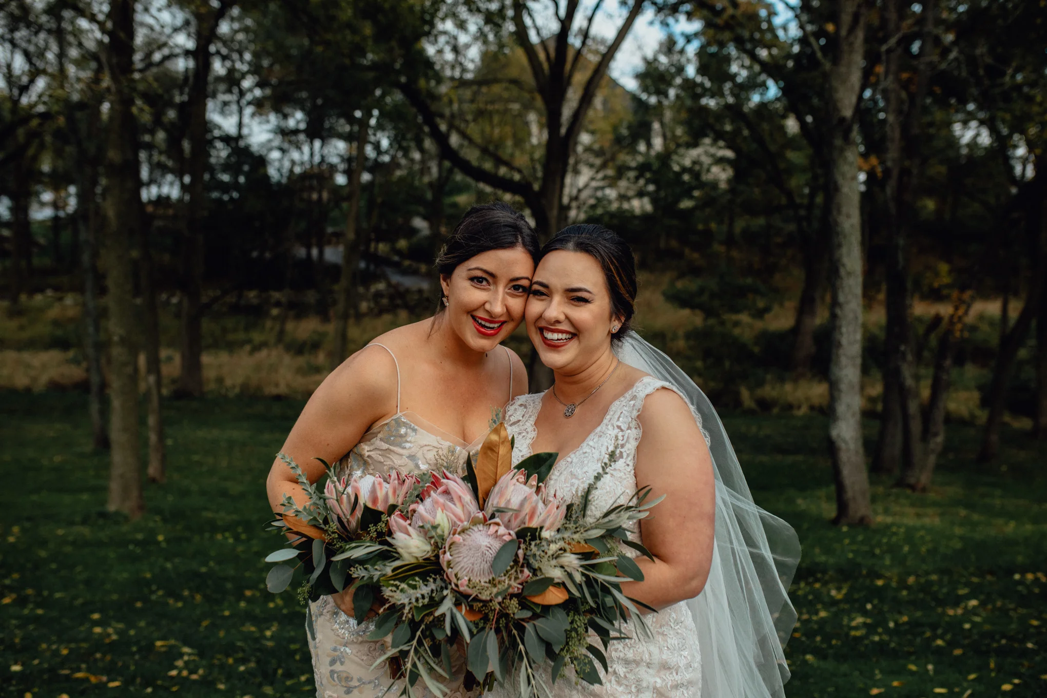 bridesmaid-smiling-with-bride-in-grass.jpg