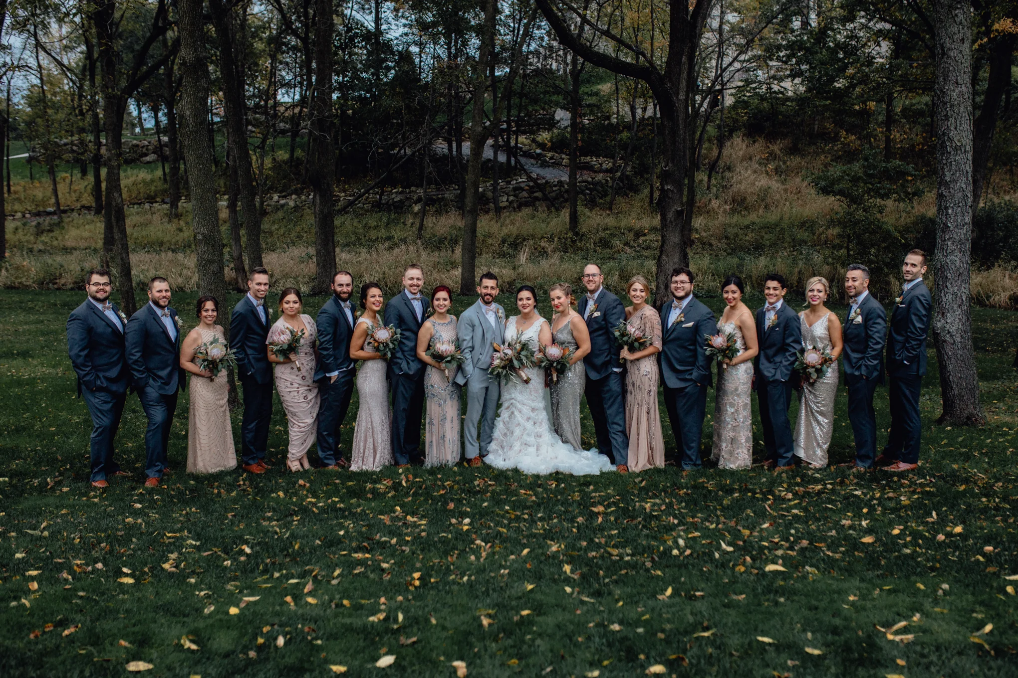 bridesmaids-and-groomsmen-smiling-in-grass.jpg