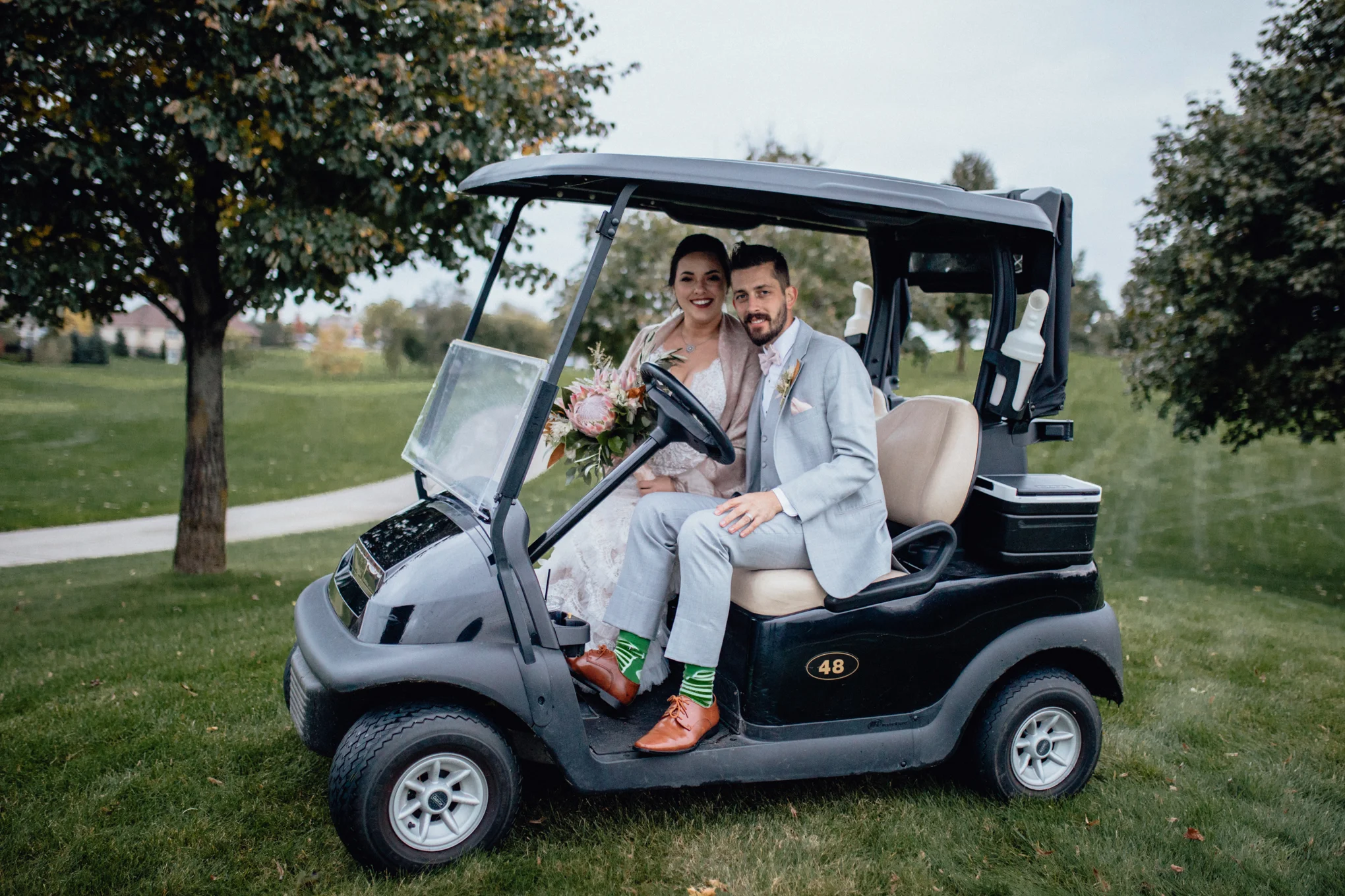 bride-and-groom-on-golf-cart-at-brandybrook.jpg